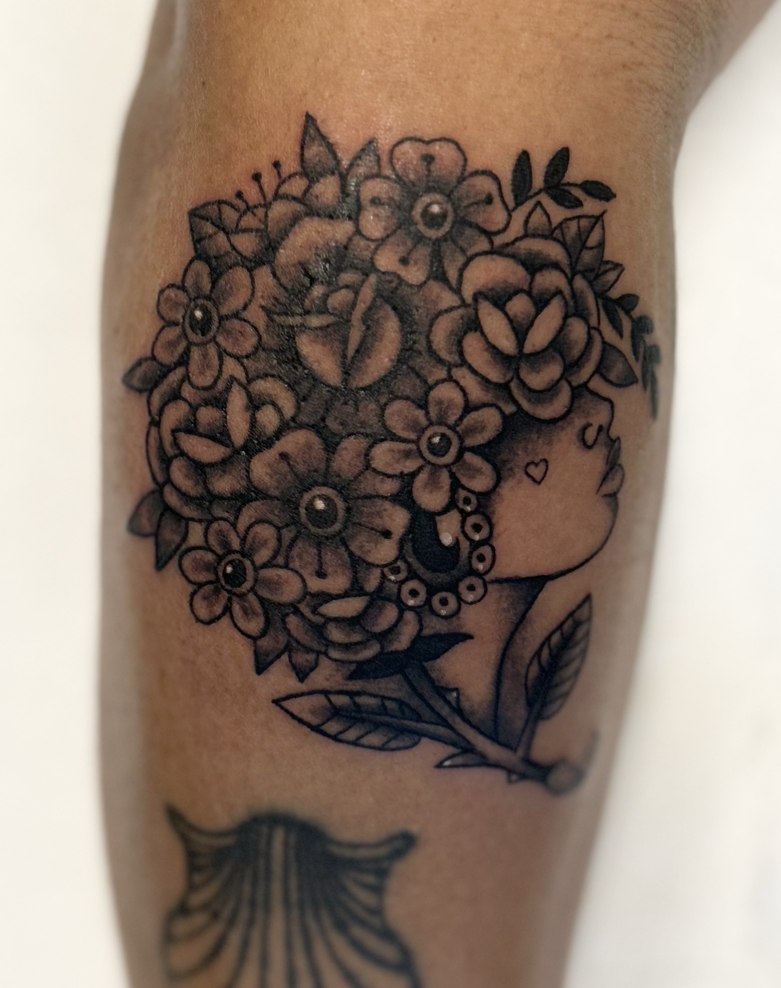 Afro‑Americana black & gray portrait tattoo of woman with floral afro, cultural style