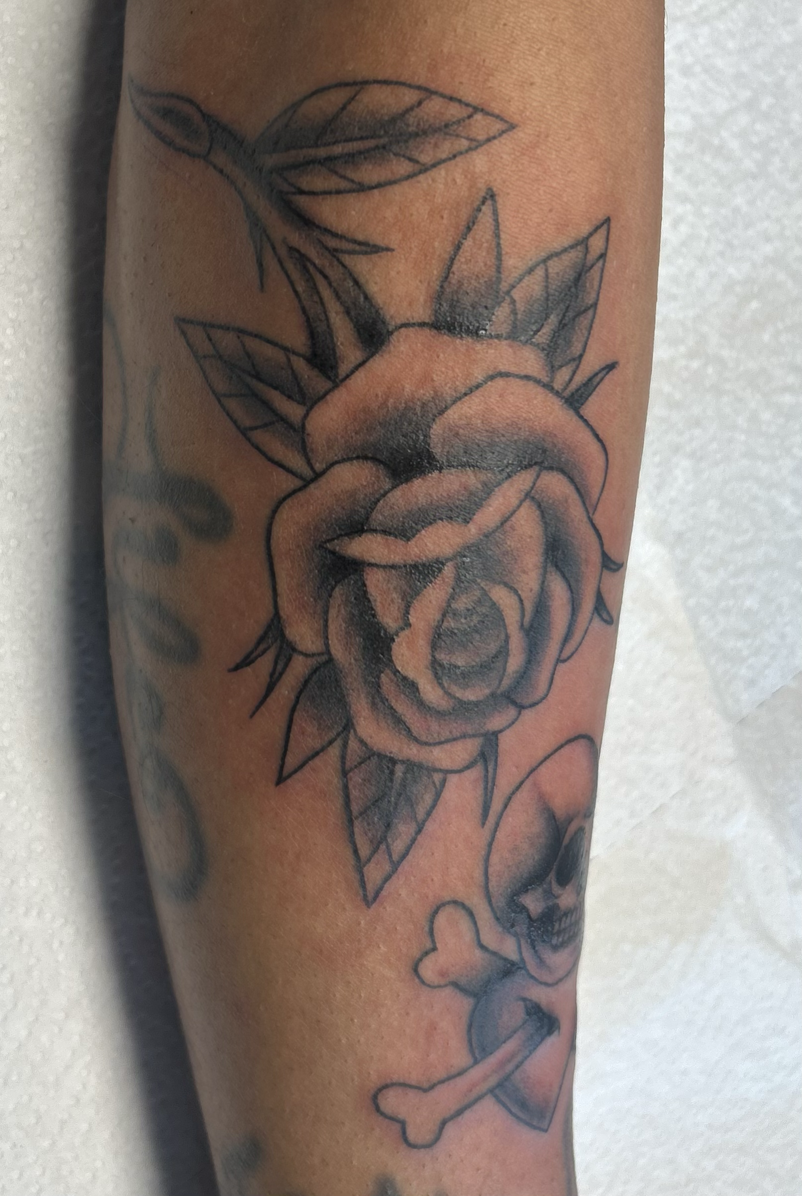 Neo‑traditional black & gray rose filler tattoo