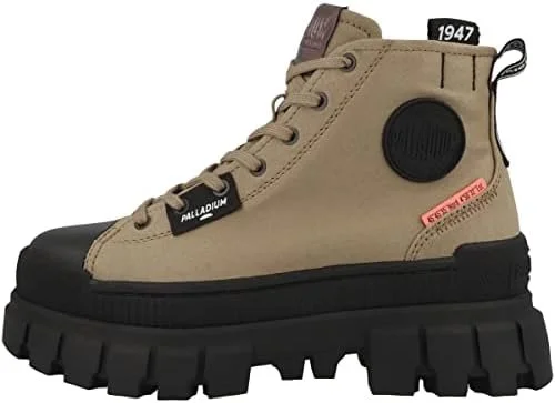 A beige high-top sneaker with a thick black sole and black rubber toe cap, featuring black and red patches, and a black circular detail on the outer side.