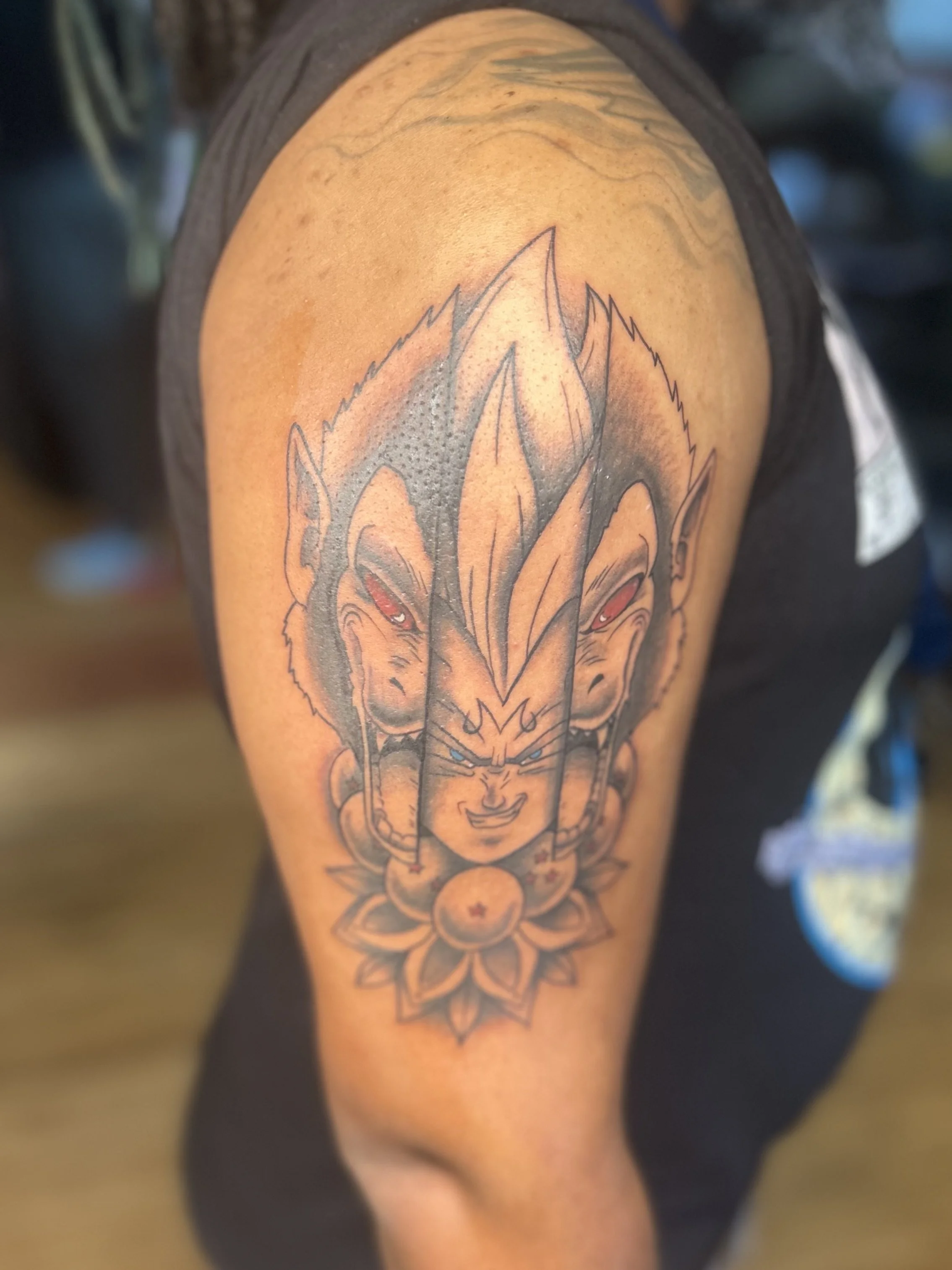 Custom Dragon Ball Z tattoo featuring Ozaru and Majin Vegeta with dragon balls and flower