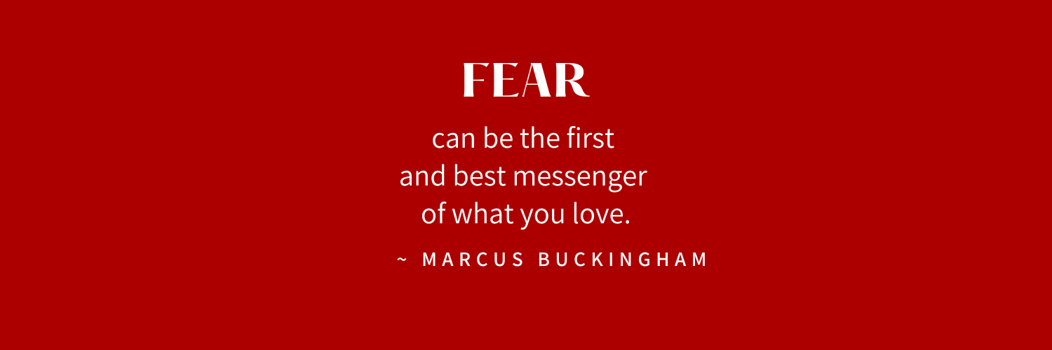 Red background with an inspirational quote about fear and love. The quote by Marcus Buckingham highlights that fear can be a messenger of love.