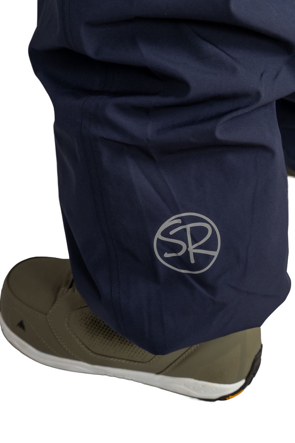 Close-up of Snowripper logo near left ankle on Crown Blue Drift Pants.