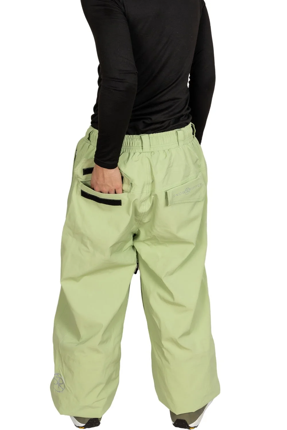 Back view of Snowripper Drift Pants in Mist Green with hands in back pockets highlighting logo placement.