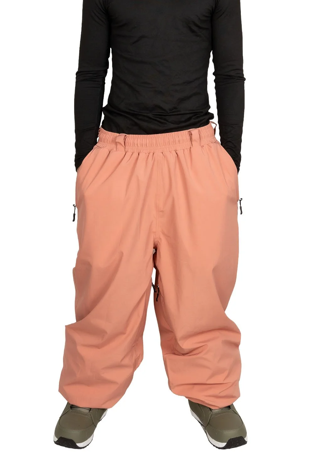 Front view of Snowripper Drift Pants in Coral Beacon with hands in pockets showing street-ready fit.