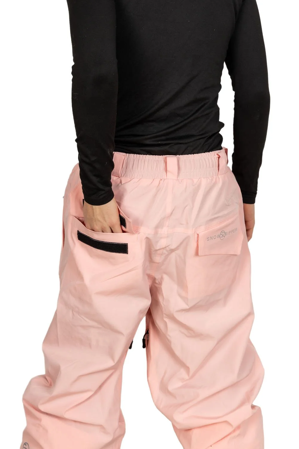 Back view of Snowripper Drift Pants in Pink a boo with hands in back pockets highlighting logo placement.