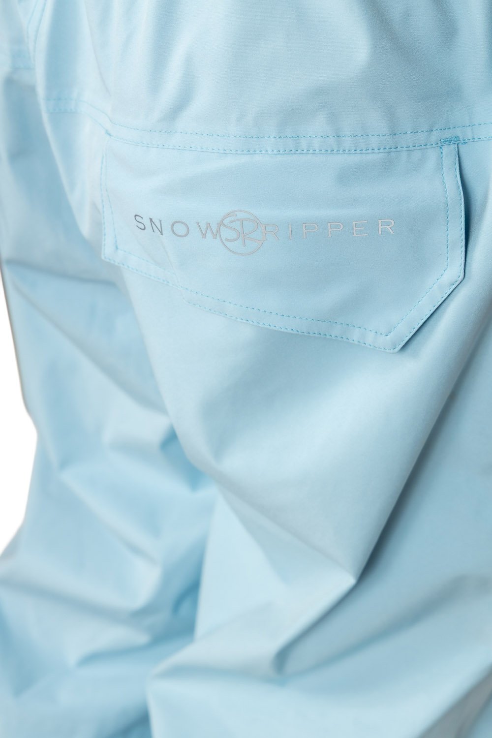 Close-up of Snowripper logo on back pocket of Ballad Blue Drift Pants.
