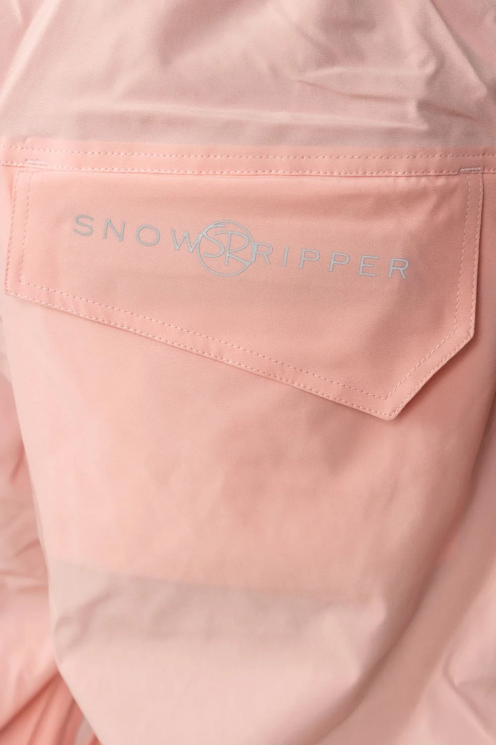 Close-up of Snowripper logo on back pocket of Pink a boo Drift Pants.