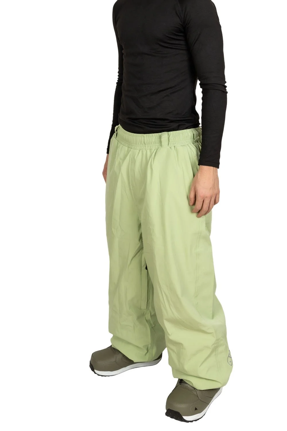 Front angled view of Snowripper Drift Pants in Mist Green showing full snowboard silhouette.