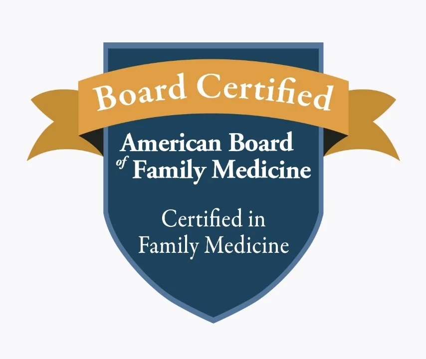 A shield-shaped badge with a gold banner reading 'Board Certified' and text indicating certification in family medicine by the American Board of Family Medicine.