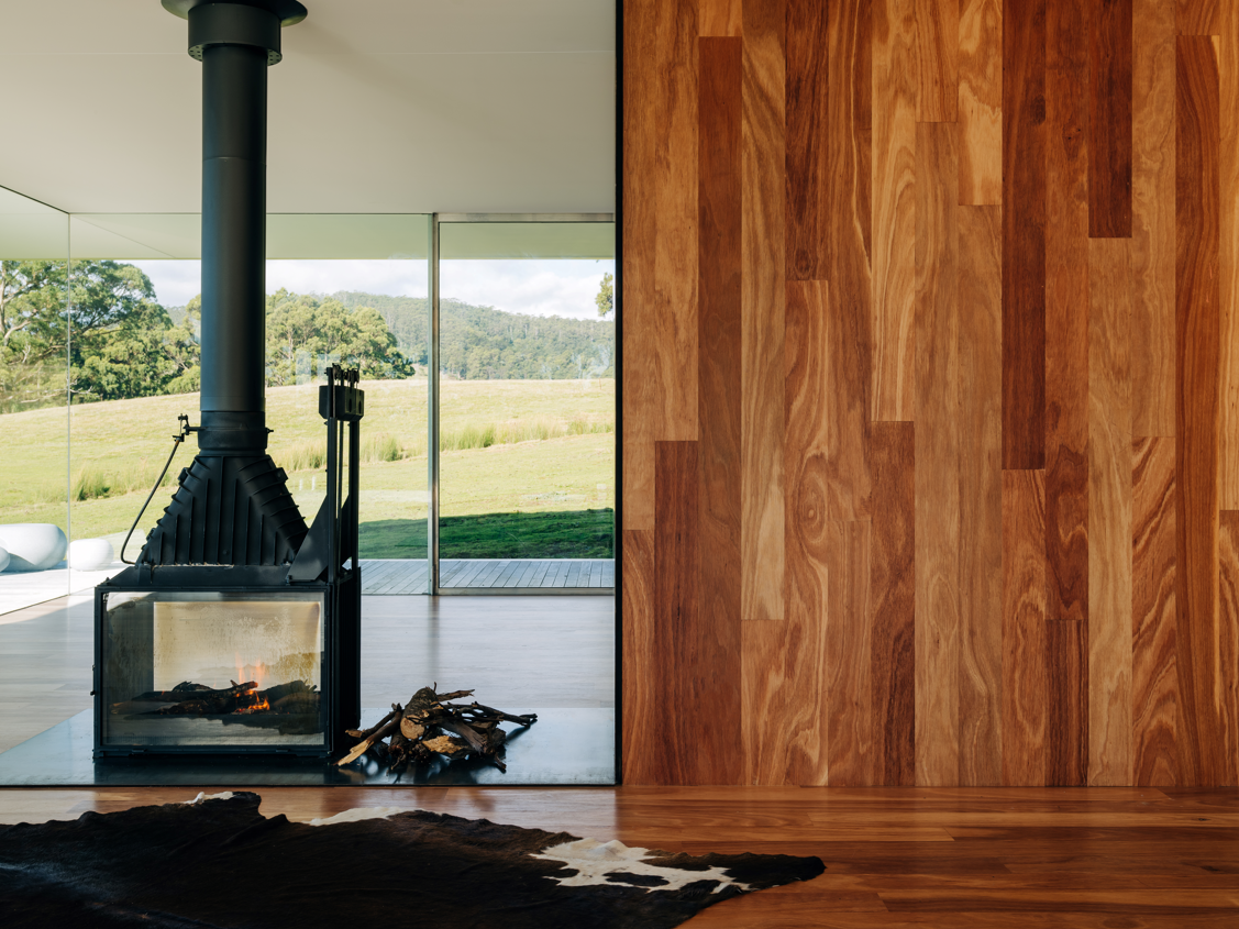 ArmourFloor Australian hardwood flooring extending from the floor to a feature wall in a contemporary architectural interior