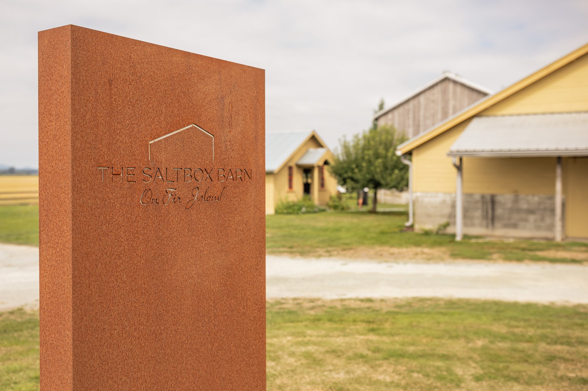 You may not know it from the road, but just beyond these yellow buildings sits the heart of our farm, the Saltbox barn itself.

Guests are always surprised by its scale when they walk through the gates. The wide &amp; open concrete floors, soaring wo