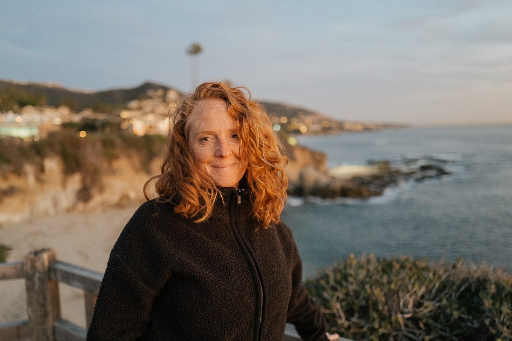 Malaurie Hotier, grounded psychic medium, on the California coast at sunset