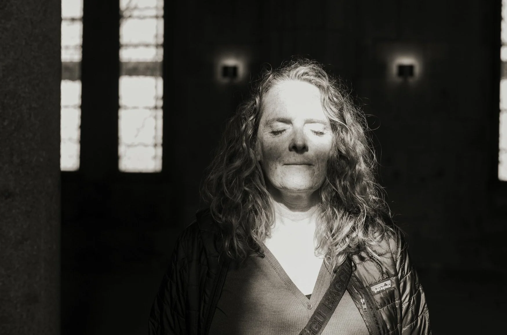 Black and white portrait of psychic medium Malaurie Hotier with her eyes closed