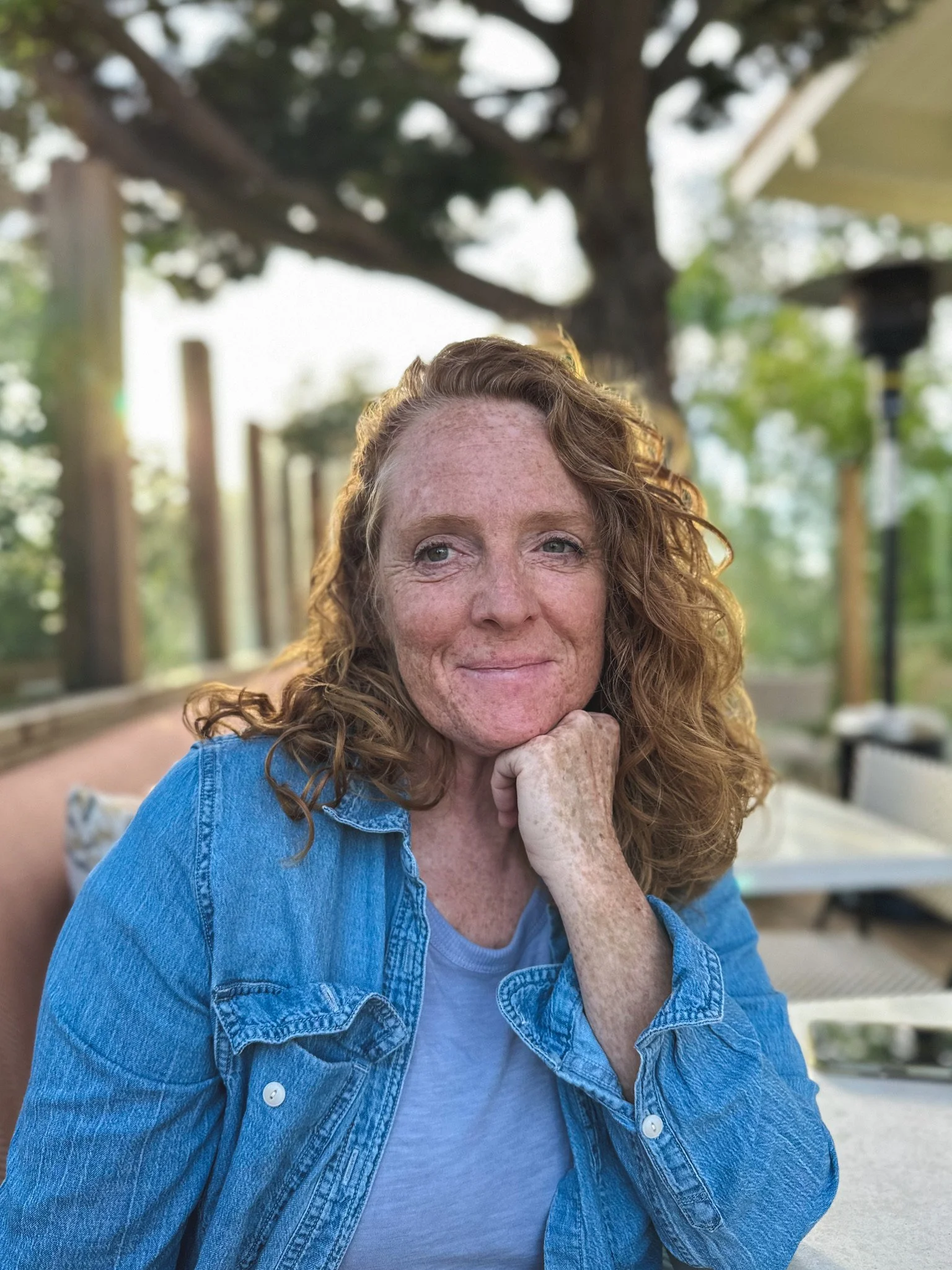 Malaurie Hotier, grounded psychic medium and spiritual teacher, outdoors under a tree