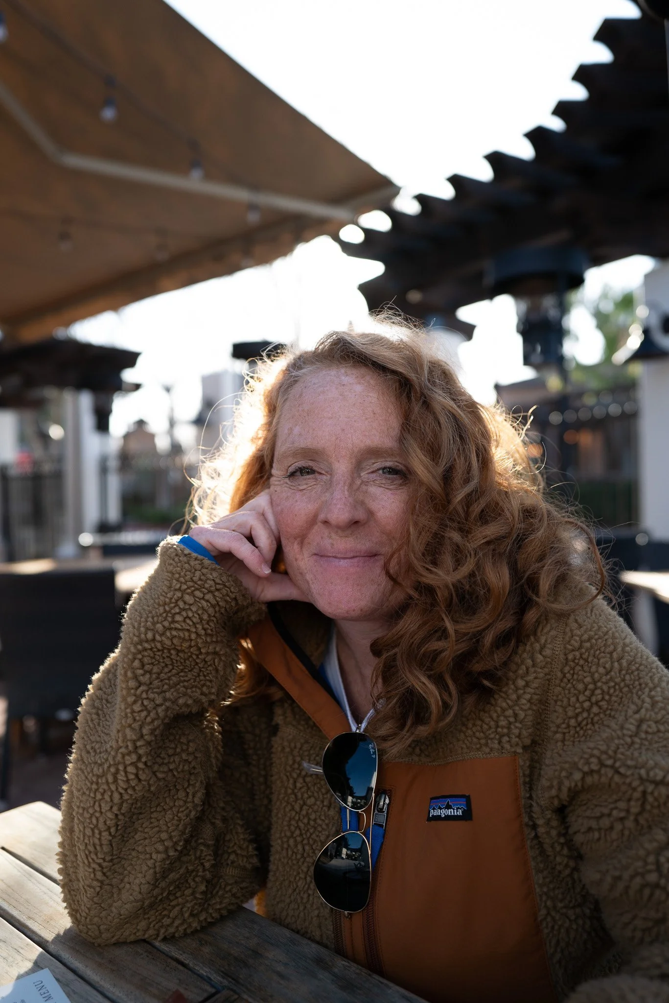 Malaurie Hotier resting her chin on her hand, outdoors in a brown jacket