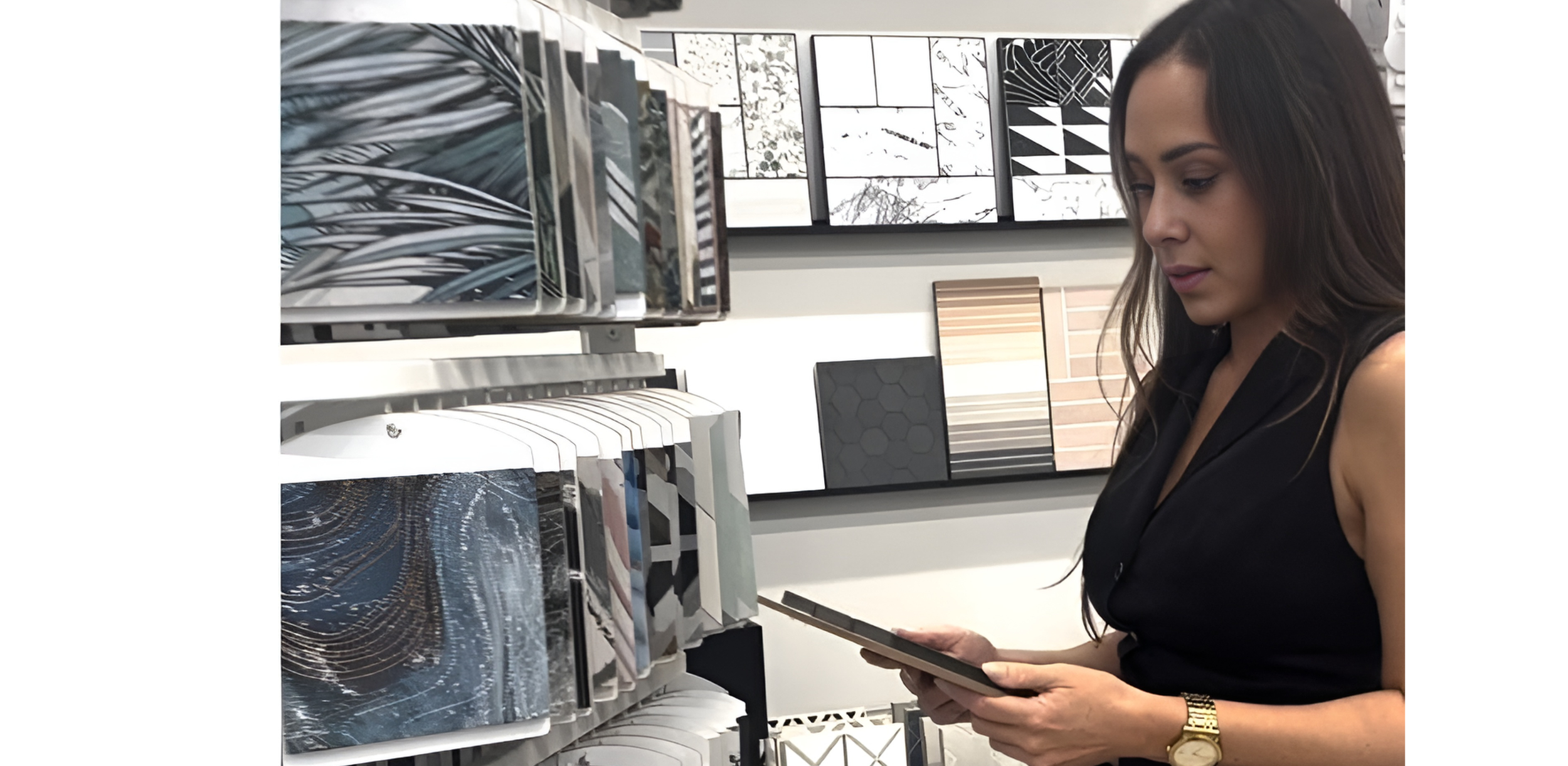 Woman examining tiles in a store, featuring various tile samples on a shelf and display wall, including patterns and textures.
