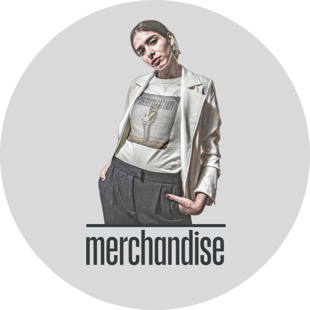 A stylish woman wearing a white t-shirt with a design by Maker Street Studio. The t-shirt reads "Childless Cat Lady" and depicts a fluffy white cat with human-like traits, dressed in a stylish white power suit.