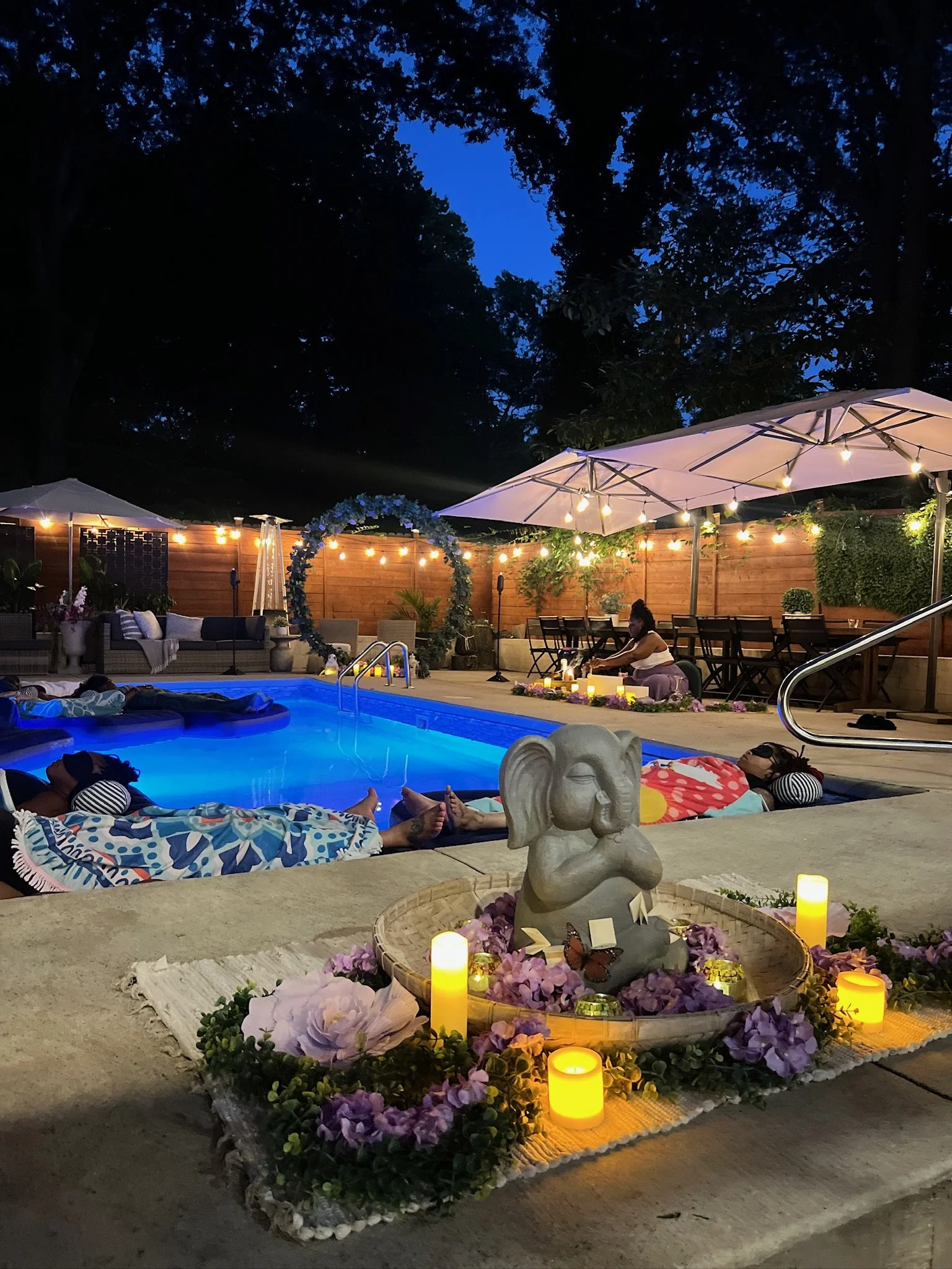 Evening floating sound bath with sacred altar, LED candles, and guests in pool floats – full moon ritual, nervous system reset, Atlanta healing event