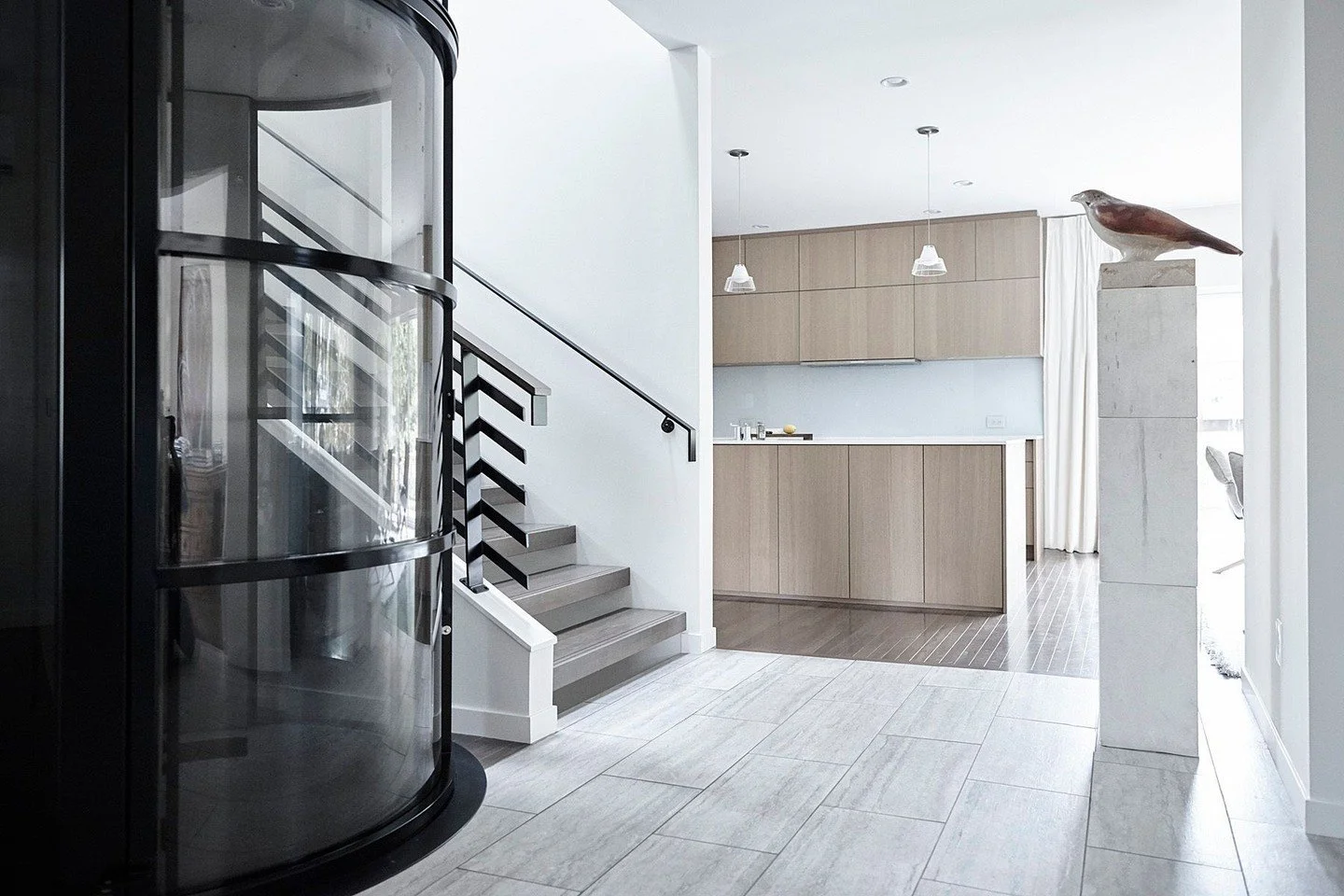 Designed for aging-in-place without compromise. This interior renovation centers around a pneumatic vacuum elevator inserted into the heart of the existing three-story home&mdash;providing seamless access to all levels while becoming a defining archi