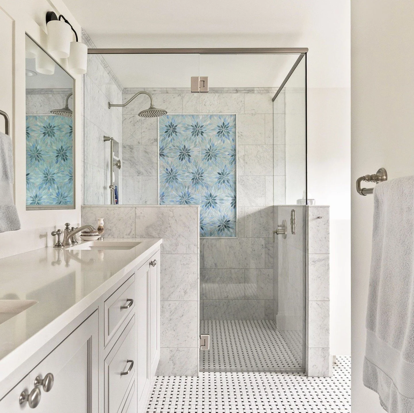 Natural light, soft neutral colors, and floral blue tiles create a timeless design for this bathroom in a custom remodel by H2D Architecture + Design in the Magnolia neighborhood of Seattle. 

architect and interiors @h2darchitects
builder @crescentb