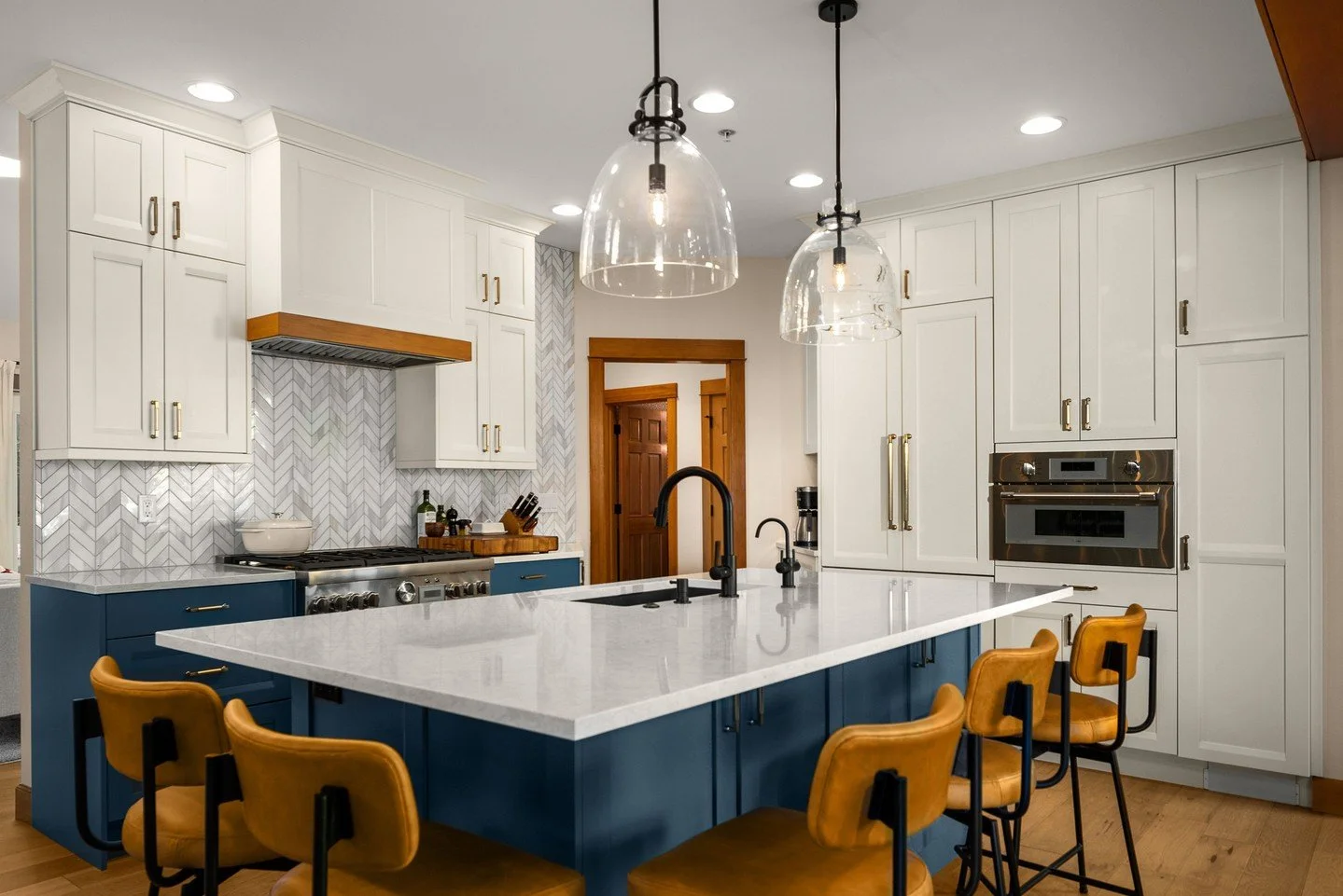 Our focus in this Seattle interior remodel was to create a sense of flow between spaces, balancing efficiency with a gorgeous, grounded space for entertaining. 

White shaker cabinetry keeps the space bright, while the navy island introduces depth an