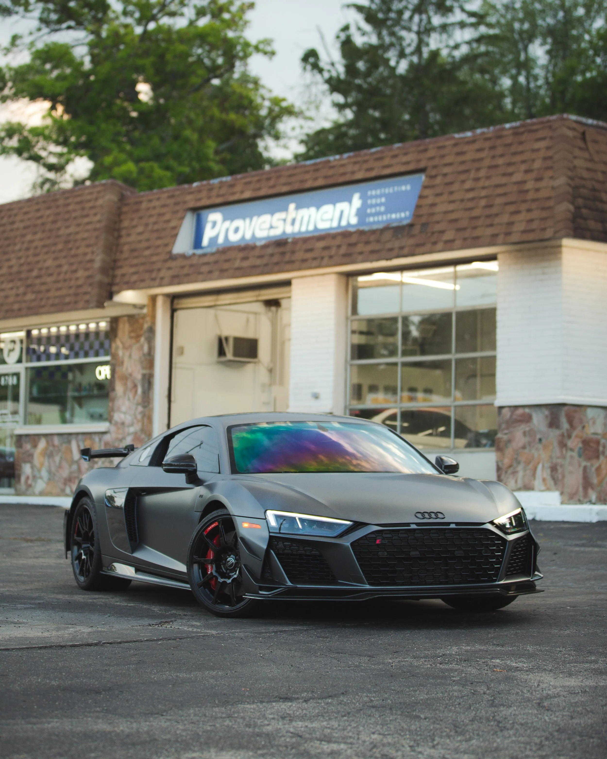 Matte grey Audi R8 with Provestment Pure PPF and STEK and ceramic window tint parked in front of Provestment USA shop – premium paint protection film and ceramic window tint installation