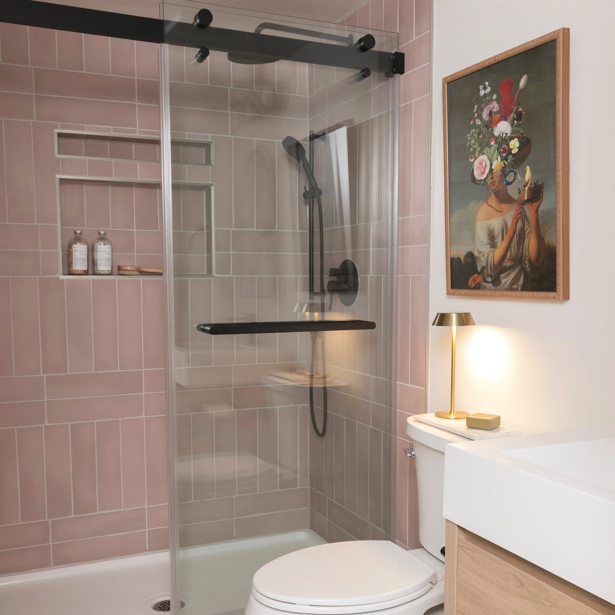 Ensuite Goals ✨
Pretty pink tiles, custom shower niches, clean lines and feminine touches for this primary bath.
Swipe to see the gorgeous wall sconce from @light_house_co 

📷 @melissaskoda