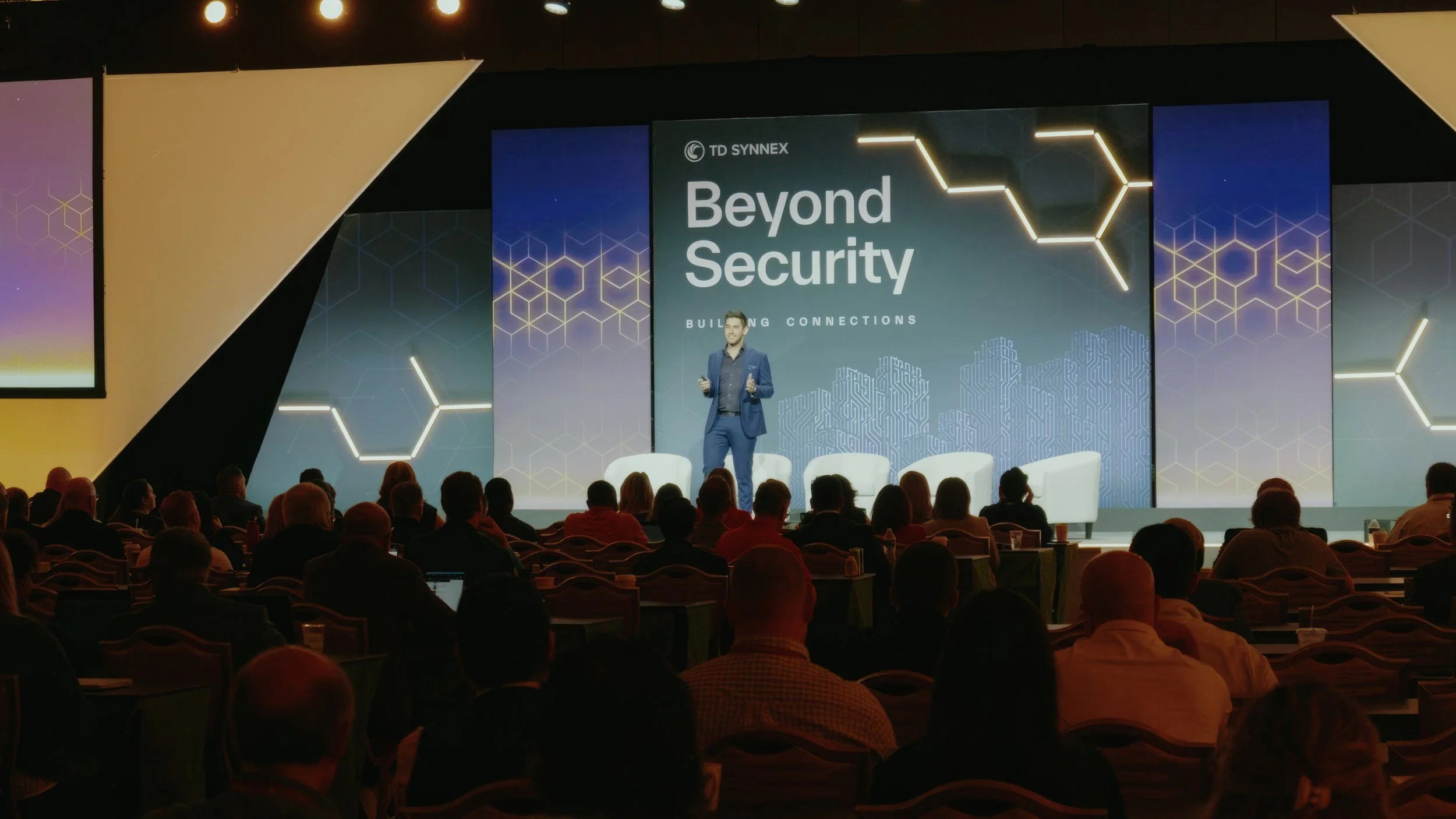 Laurie’s customers, Mariana and Carmen holding hands on a green lawn on their wedding day.