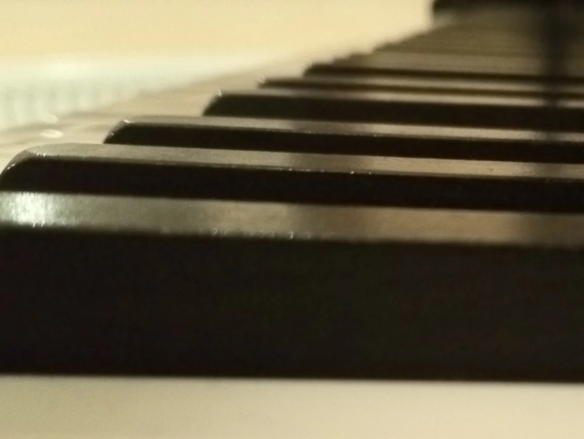 Close-up view of piano keys from a low angle.