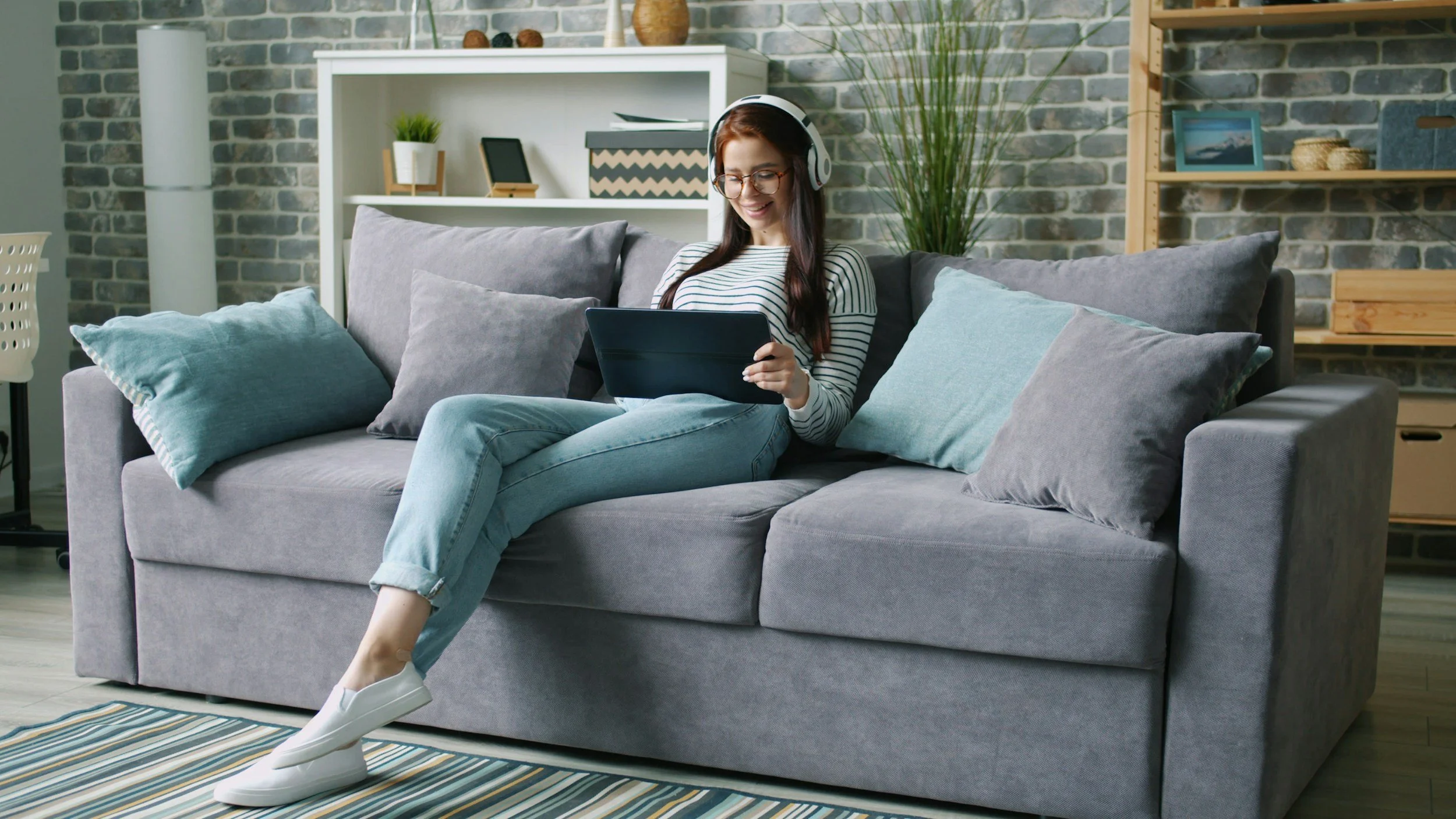 Person using a laptop for a telehealth psychology appointment from home