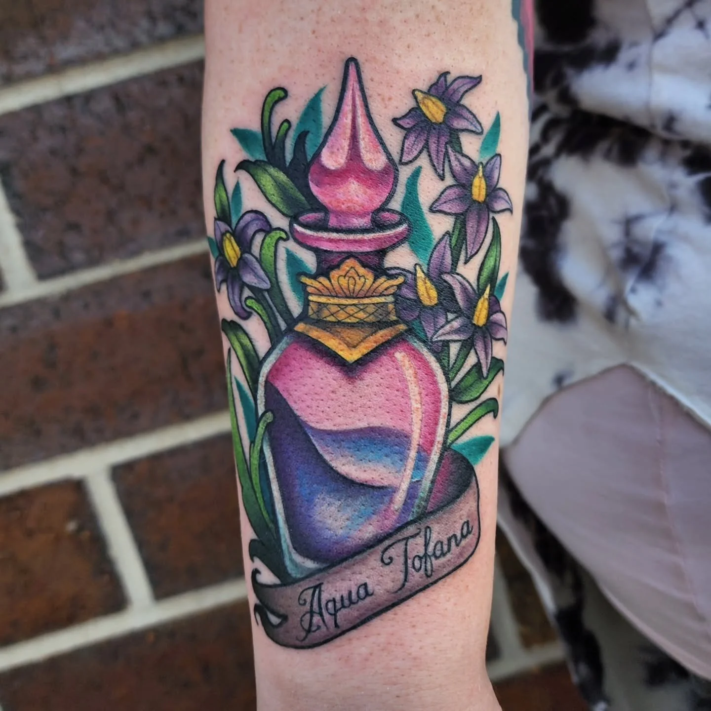 A couple of tattoos from recently. 💕 
First one is Aqua Tofana ☠️
 Aqua Tofana was a highly potent poison, likely arsenic and lead-based, created in Sicily around 1630 and used in Italy during the Renaissance and into the 18th century. It was sold b