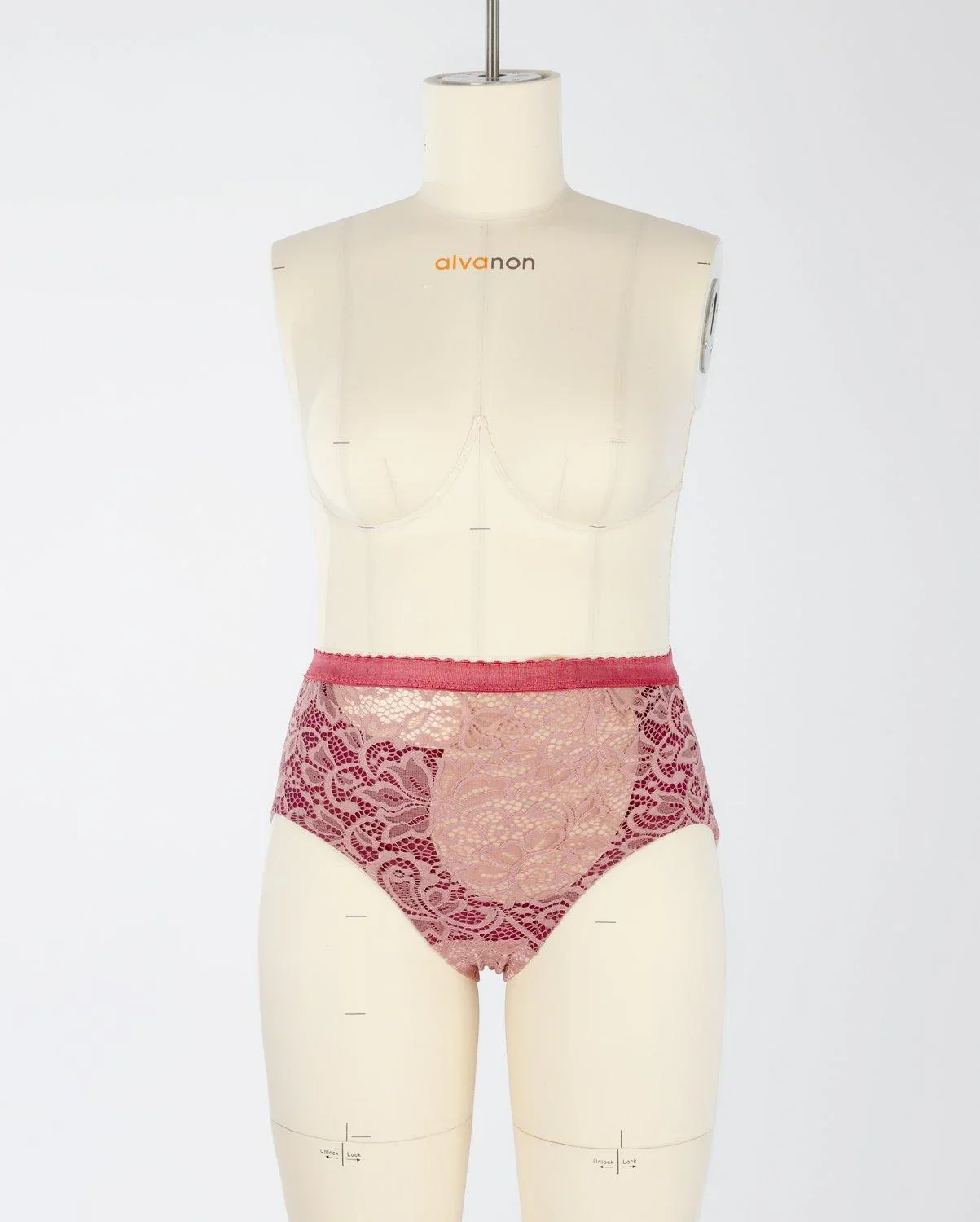 A pair of red lacy adaptive knickers on a dressmaking dummy