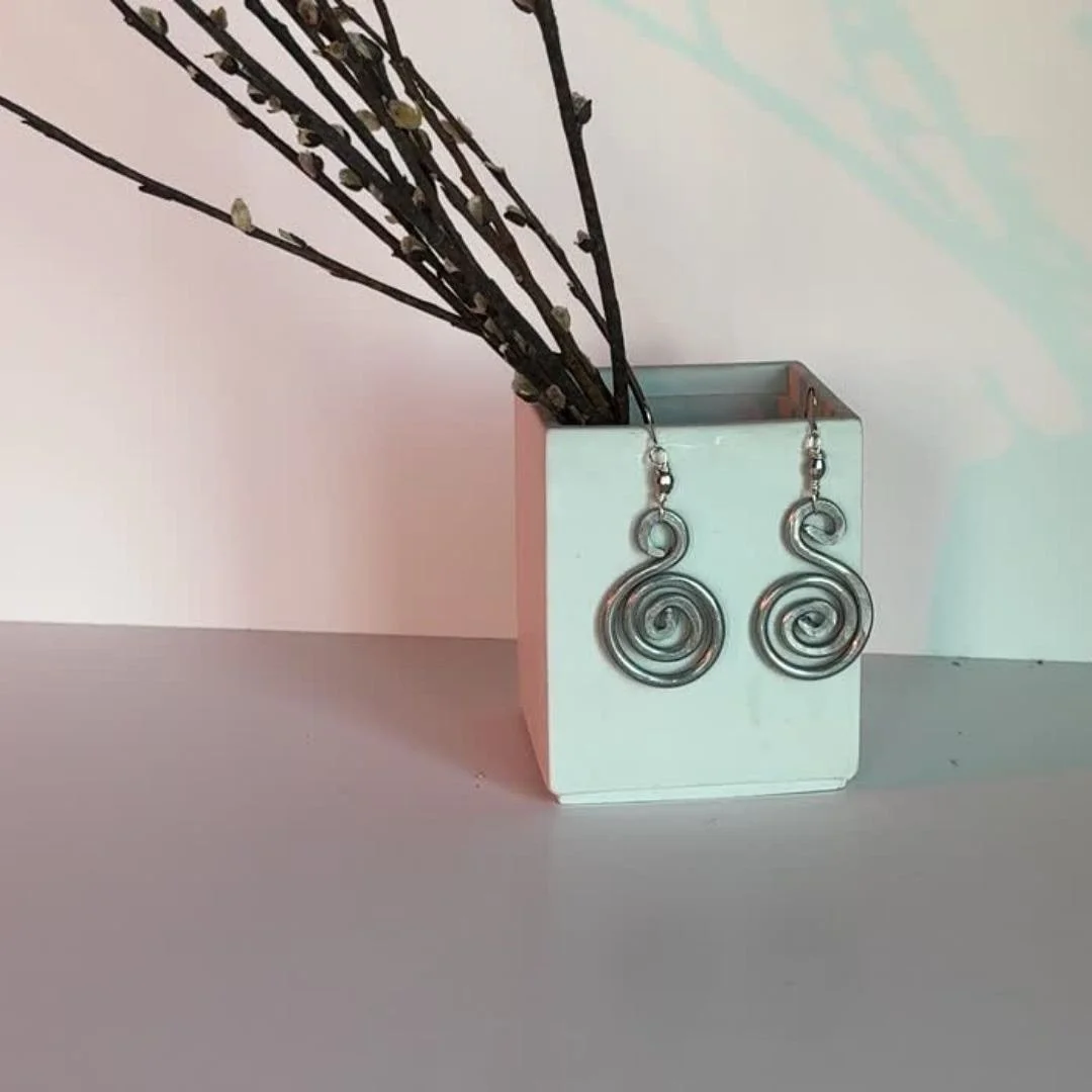 Aluminum Spiral Crystal Earrings. 
This 2&rdquo; drop set offers a lightweight yet bold alternative for everyday wear.