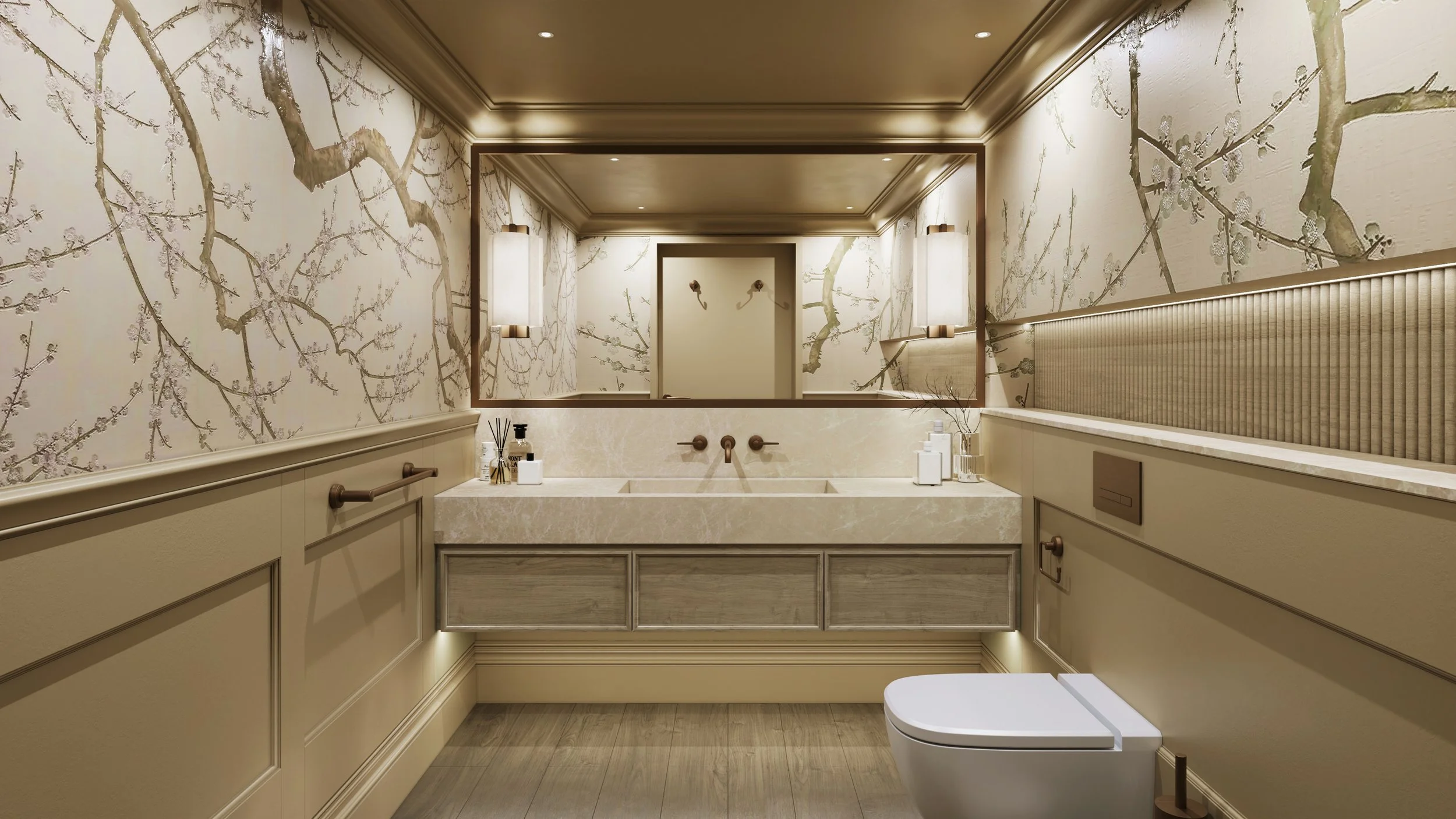 Luxury residential toilet interior featuring a large rectangular mirror with warm recessed lighting, marble sink vanity unit with grey oak drawer fronts, and wall-mounted bronze faucets. The walls are decorated with beige botanical wallpaper.