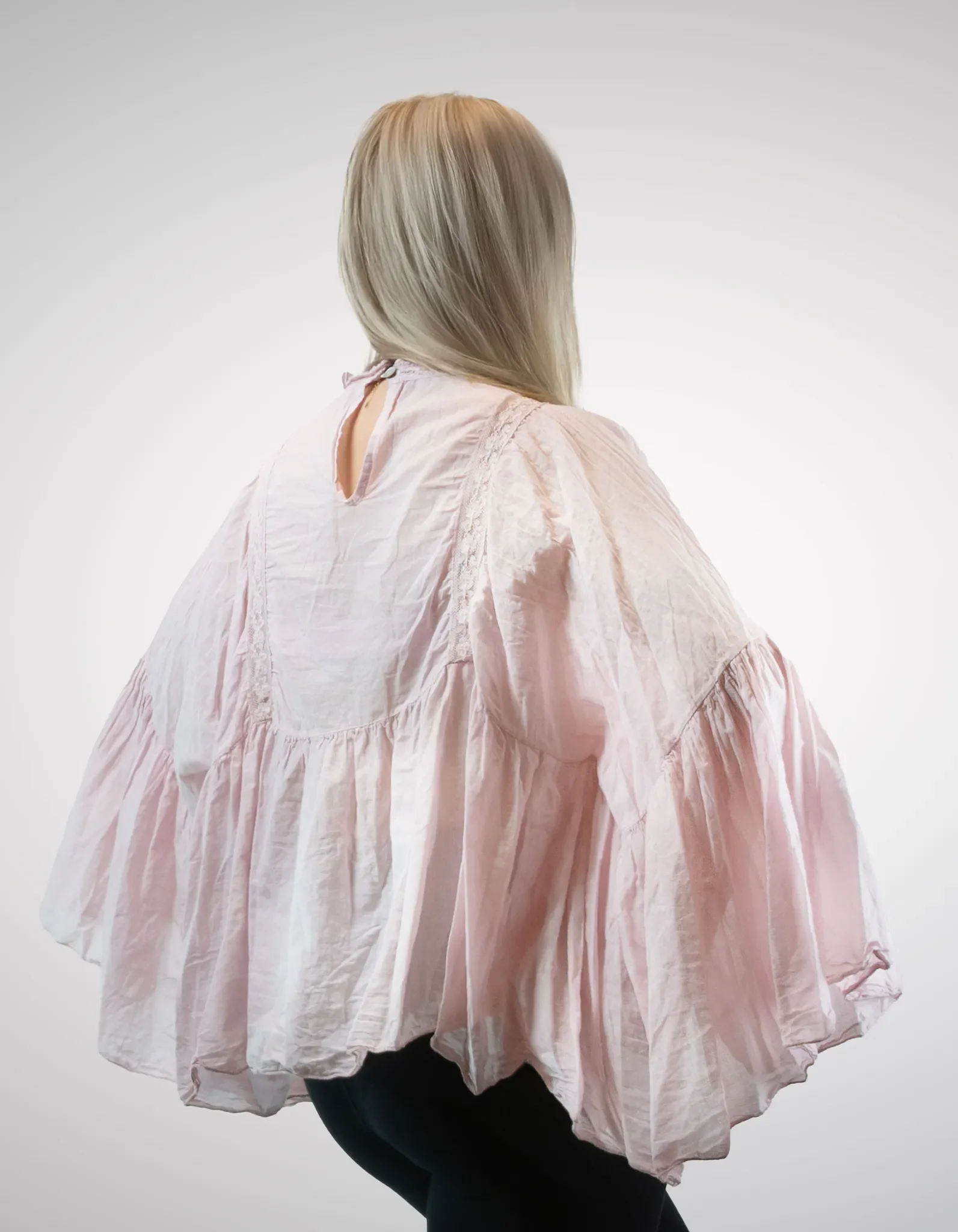Rückenansicht der Boho-Bluse in Zartrosa mit dekorativem Nackenausschnitt und feinen Spitzendetails entlang der Schultern.
