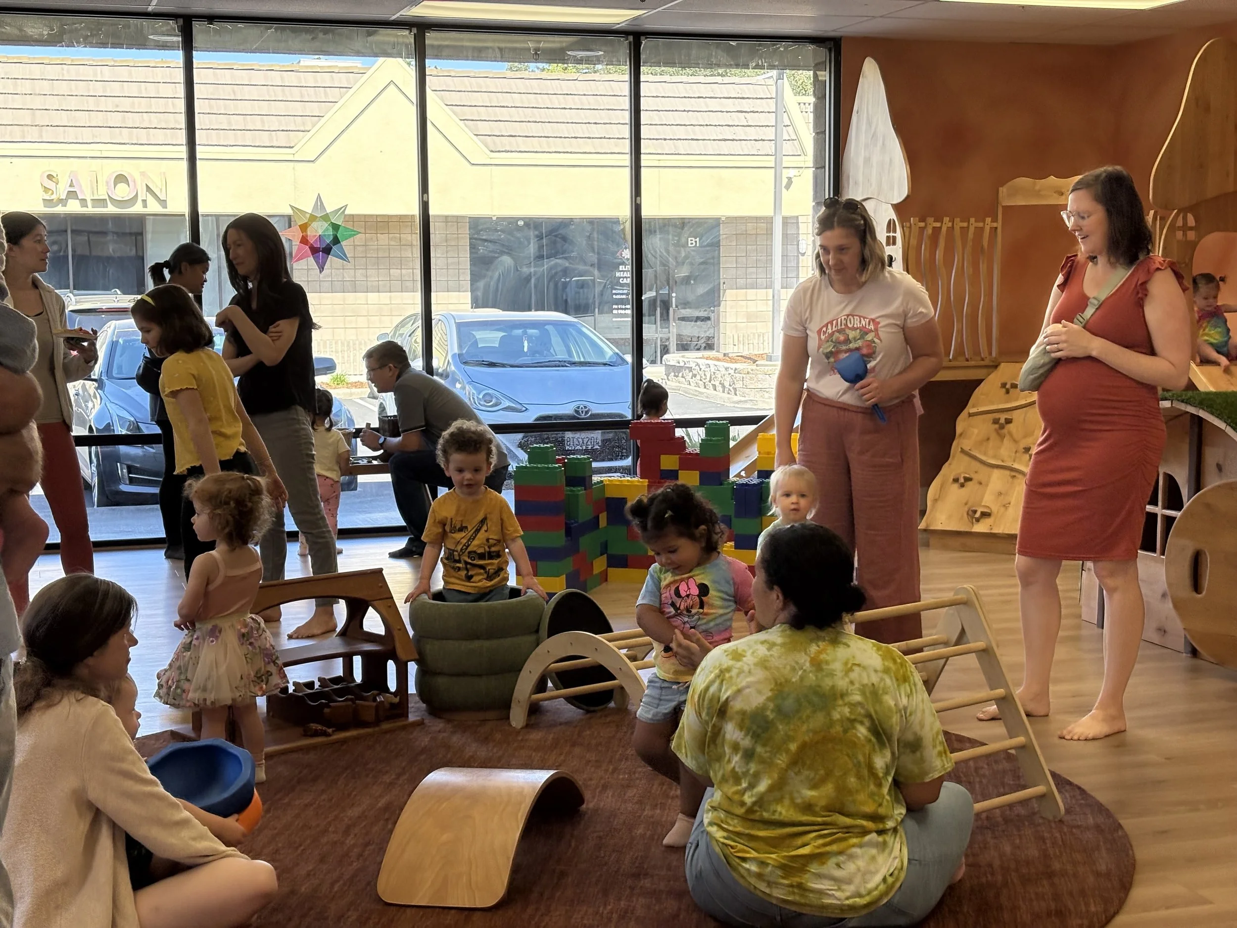 Families and toddlers enjoying unlimited play with memberships at Kindred Play Collective indoor playground in Orangevale.