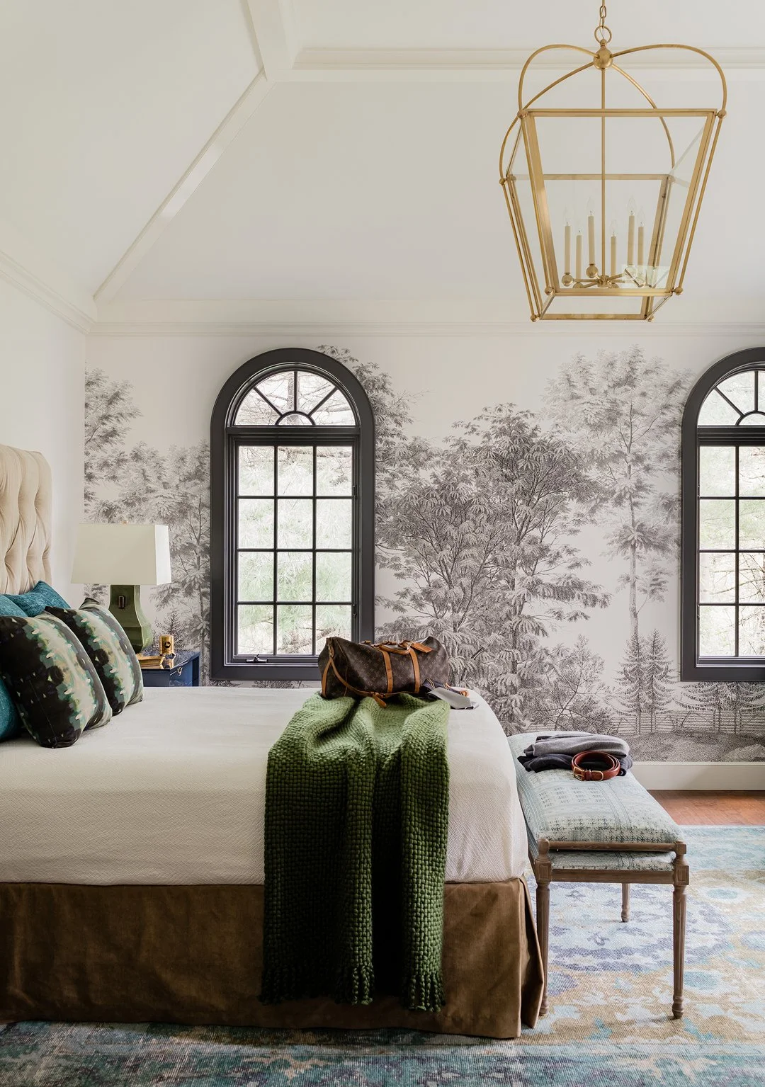 Cover photo New England Home bedroom with vaulted hipped ceiling, greige Ananbo tree mural, black arched windows