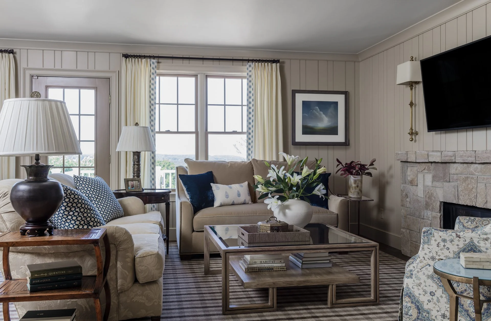 Traditional living room with beadboard paneled walls, stone fireplace, english country furnishings — luxury historic home interior design in Essex County MA by Sacris Design