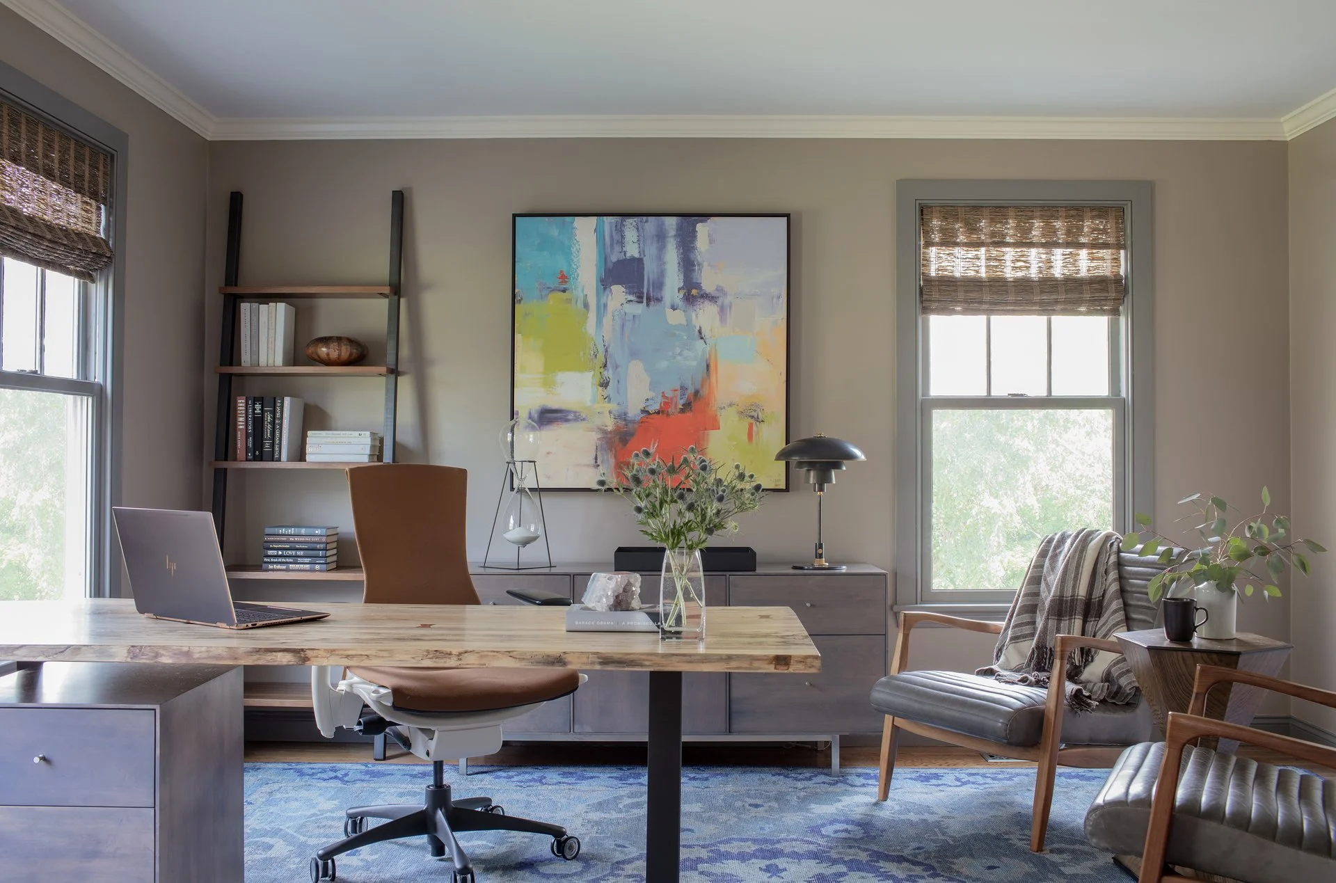 Luxury home office with live edge wood desk, colorful abstract art, gray credenza, and hexagonal flush mount — full service interior design in Essex County MA by Sacris Design