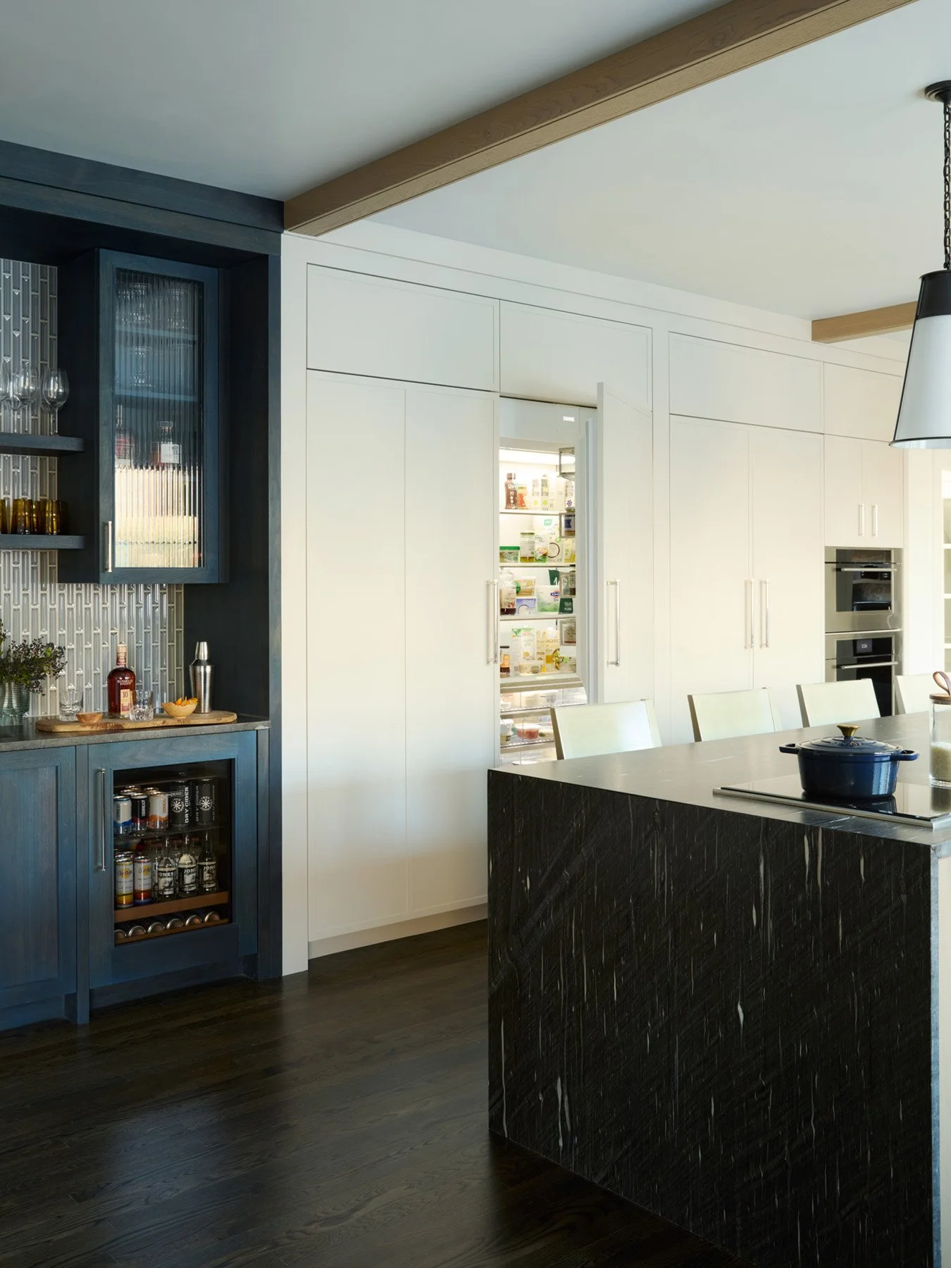 SACRIS kitchen with integrated refrigerator-freezer-adjacent to indigo-stained walnut bar and integrated wall ovens, North Andover Massachusetts