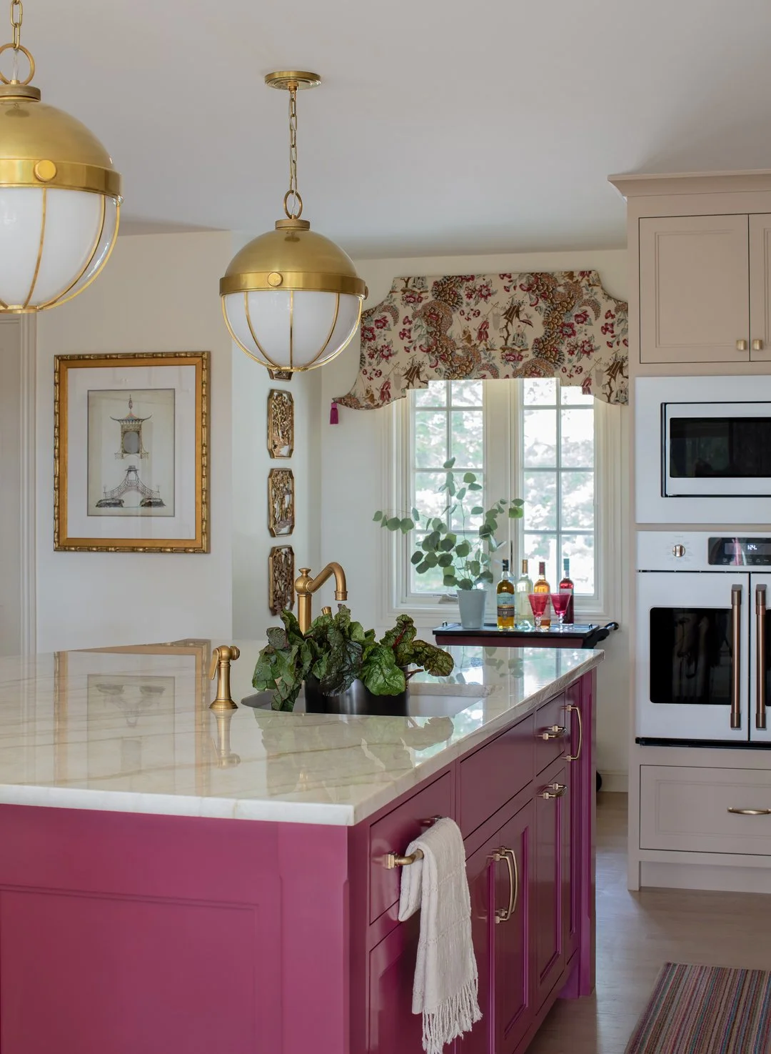 Sacris Interior Design coastal chinoiserie kitchen with bold raspberry painted island, brass nautical globe pendants and Taj Mahal quartzite countertop, New Castle NH