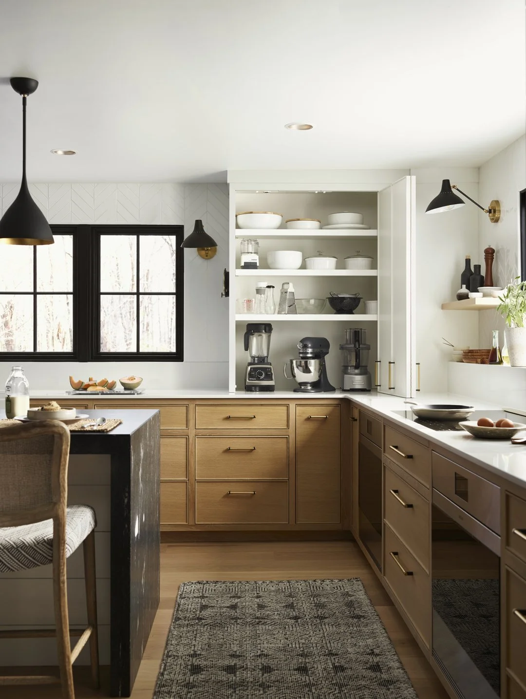 Sacris Design modern farmhouse kitchen with custom bifold pantry cabinet doors, serving southern New Hampshire, North Shore MA and Maine