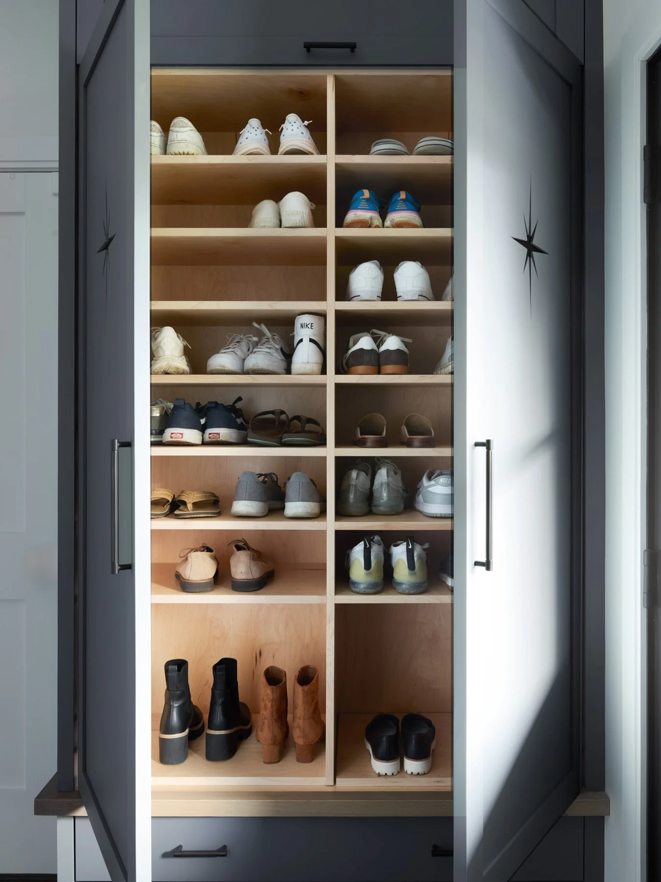SACRIS custom lighted shoe cabinet with adjustable maple shelving behind blue-gray cabinet doors, North Andover Massachusetts
