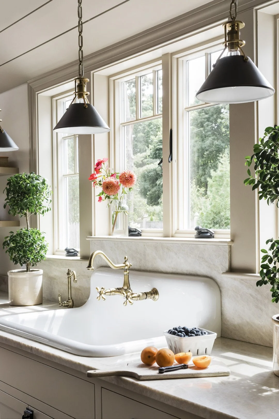 Antique-style reproduction sink with wall-mounted brass faucet in a Newburyport MA kitchen renovation by SACRIS Interior Architecture & Design