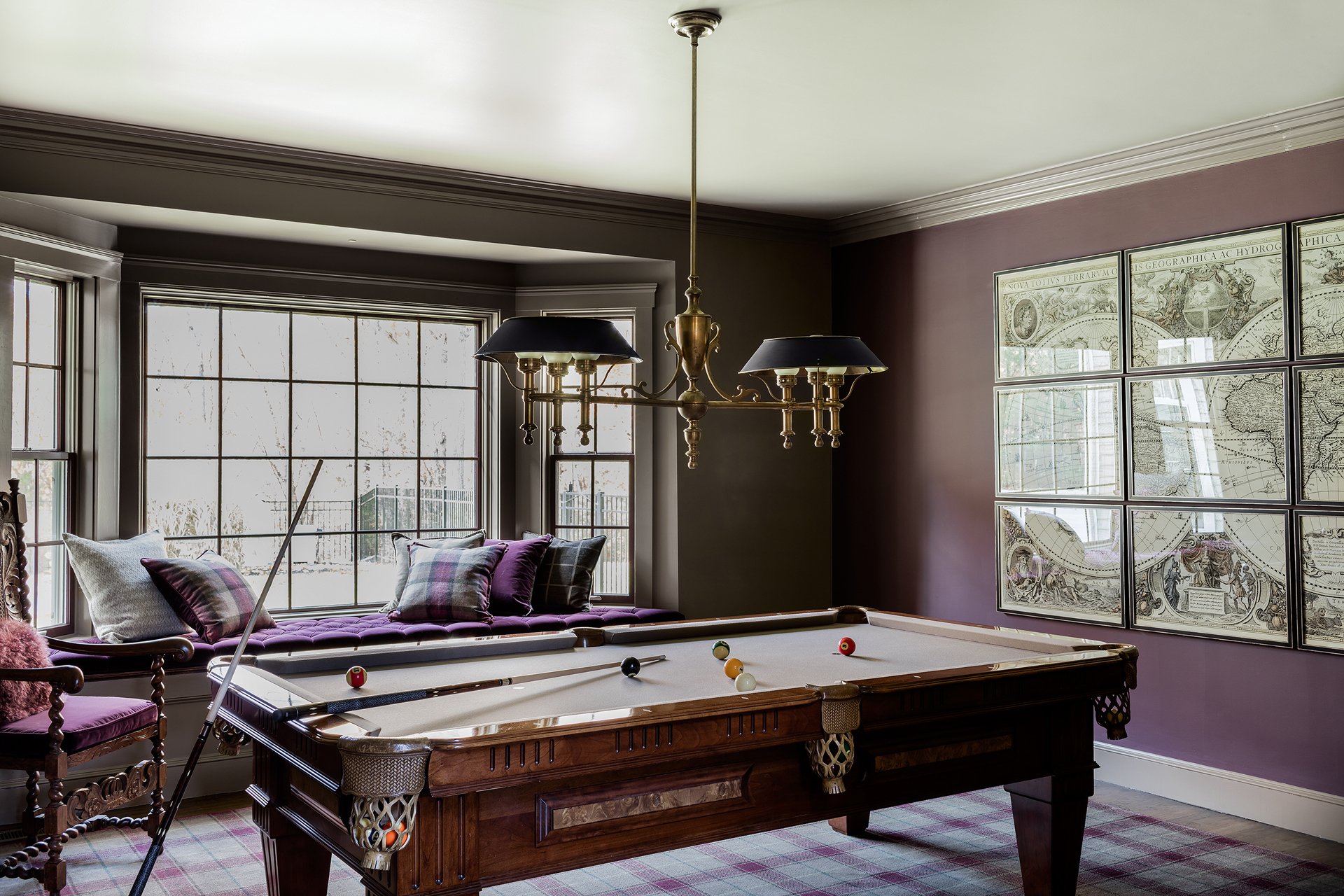 Dramatic billiard room with aubergine walls, antique pool table, tartan plaid wool carpet, and vintage map art — luxury estate interior design in Essex County MA by Sacris Design