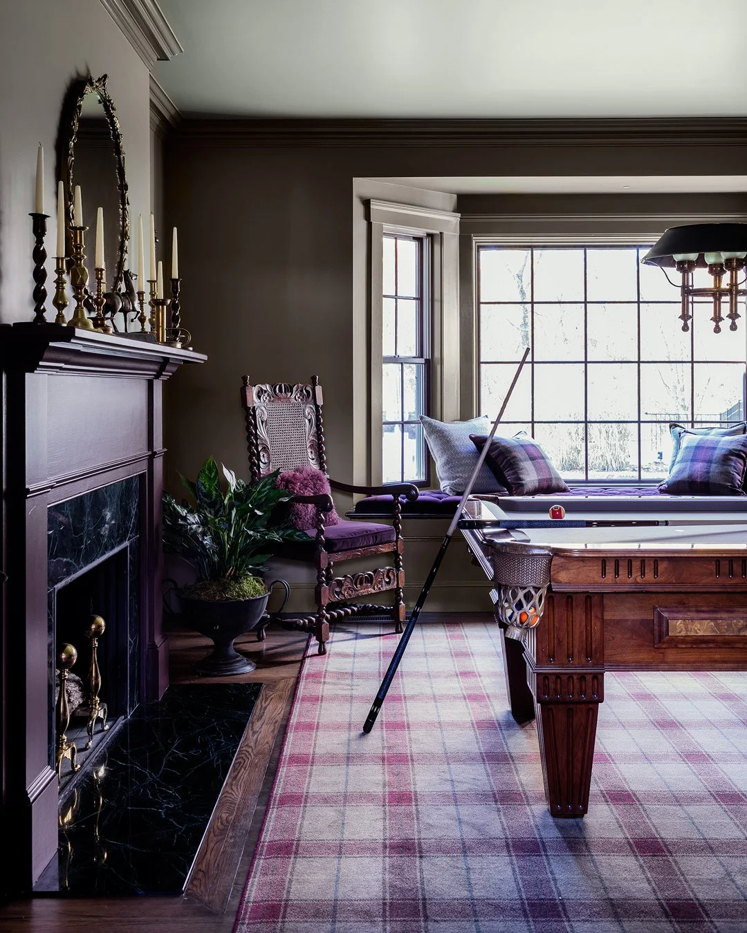 Billiard room with dark green marble fireplace surround, brass candlestick mantel, and antique carved barley twist chair — luxury estate interior design on the North Shore of Massachusetts by Sacris Design