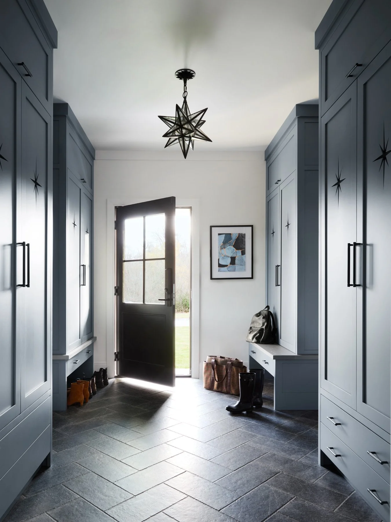 SACRIS mudroom with blue-gray custom lockers, star-detail cabinet doors, herringbone slate floor and Visual Comfort Moravian star lantern, North Andover Massachusetts