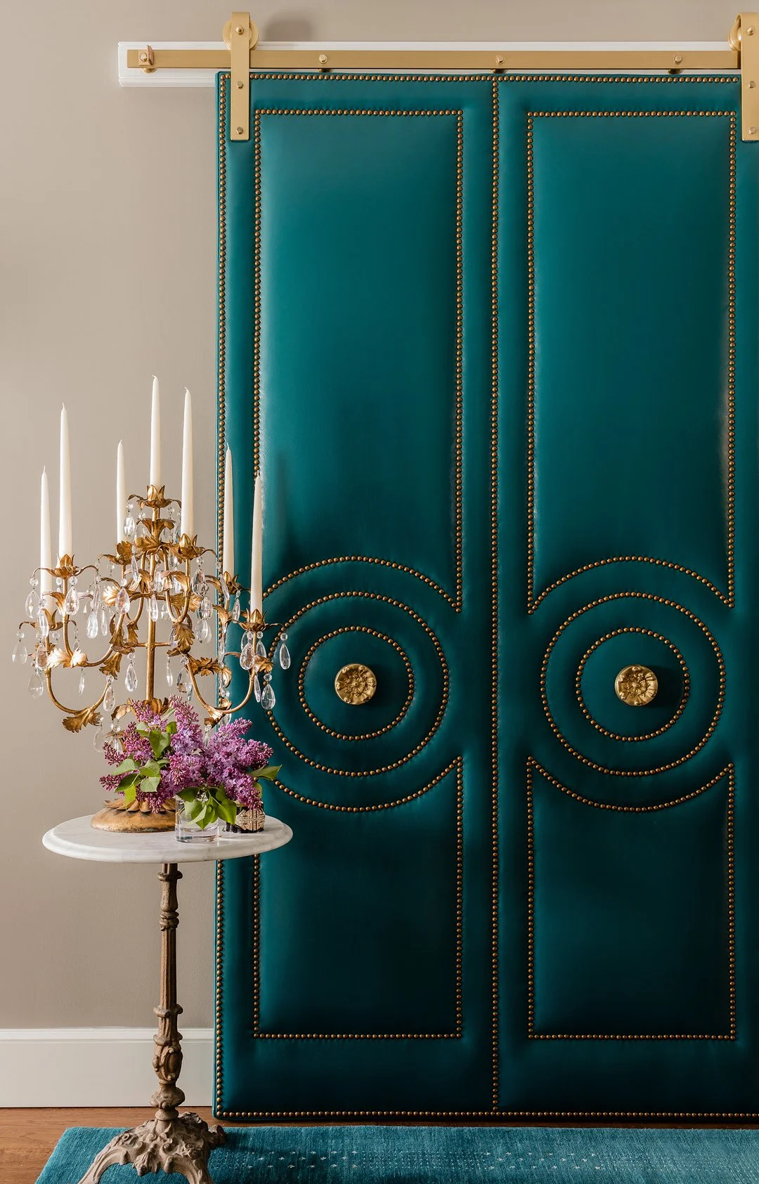 Sacris Design custom leather upholstered barn door with nailhead trim, luxury interior design Andover Massachusetts