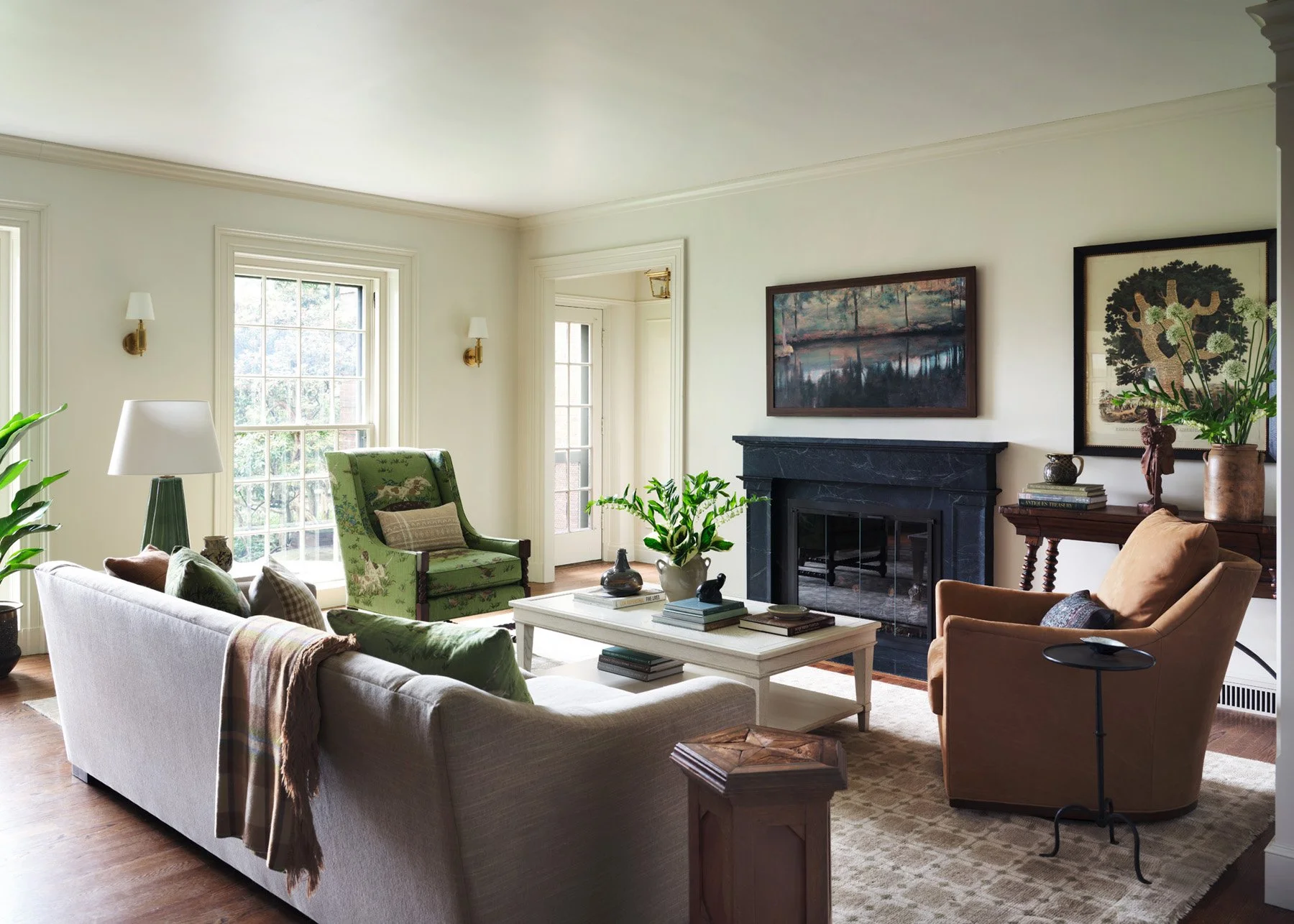 SACRIS living room with relocated custom soapstone fireplace, brass sconces, printed Schumacher fabric armchair and leather Wesley Hall swivel chair, Nashua New Hampshire