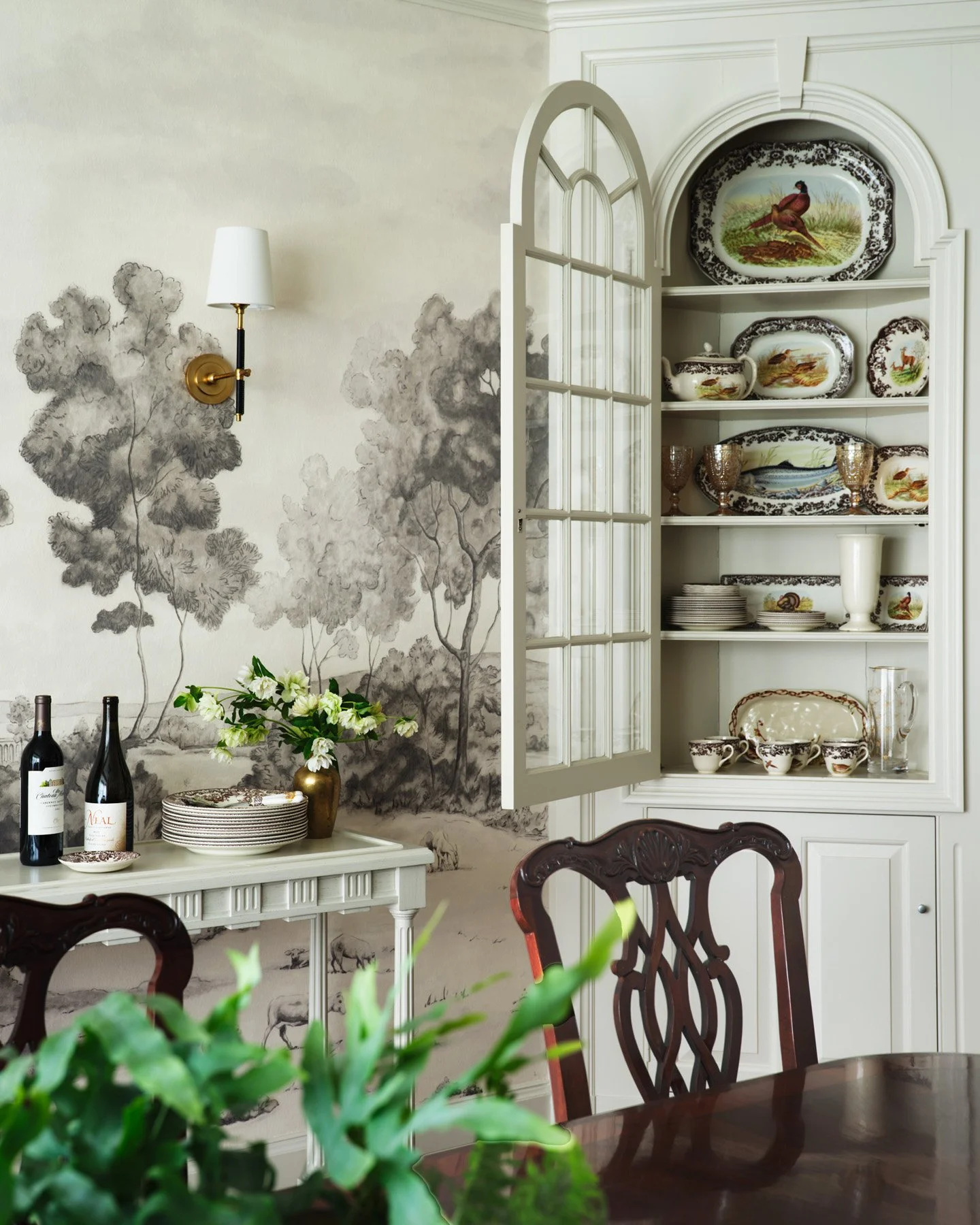 SACRIS dining room with hand-painted grisaille landscape mural and original arched china cupboard displaying Spode game bird transferware, Nashua New Hampshire